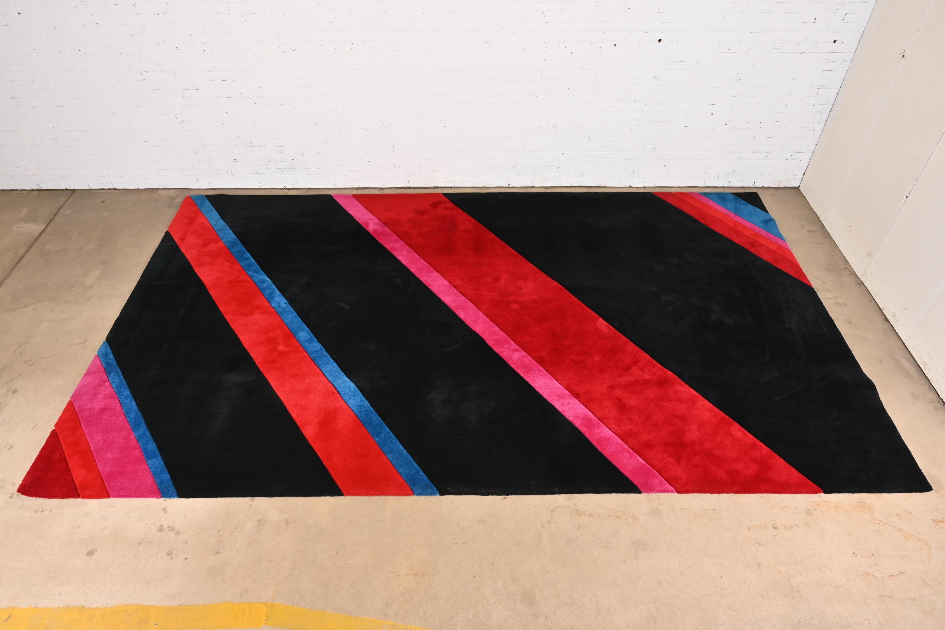 A gorgeous bespoke Modern large room size wool rug

Custom ordered from Edward Fields by Keith Conrad Design

USA, Circa 1980s

Thick wool pile, with vibrant colors in red, blue, pink, and black.

Measures: 9'4