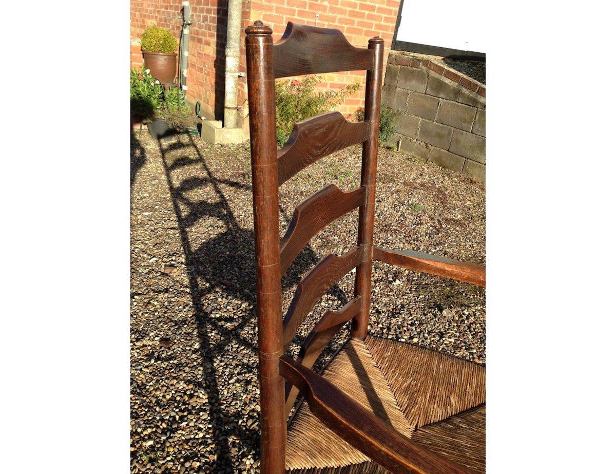 Hand-Crafted Edward Gardiner, An English Cotswold School Oak Ladder Back Rush Seat Armchair For Sale
