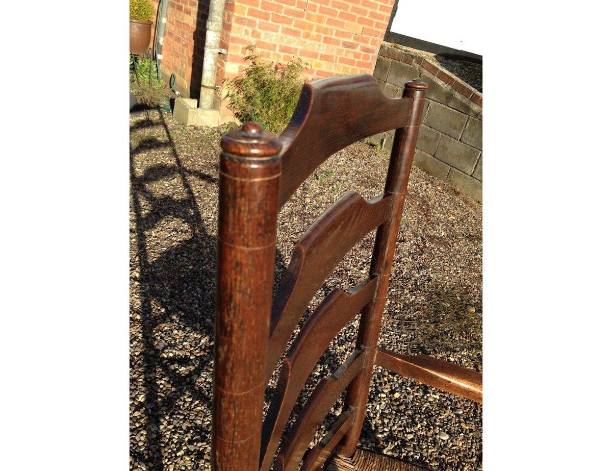 Early 20th Century Edward Gardiner, An English Cotswold School Oak Ladder Back Rush Seat Armchair For Sale