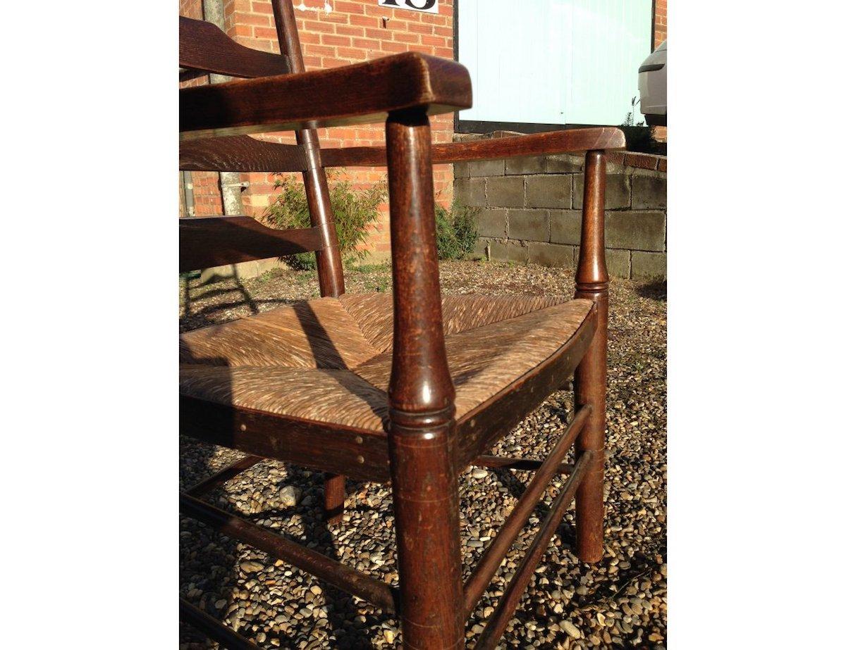 Edward Gardiner, An English Cotswold School Oak Ladder Back Rush Seat Armchair For Sale 1
