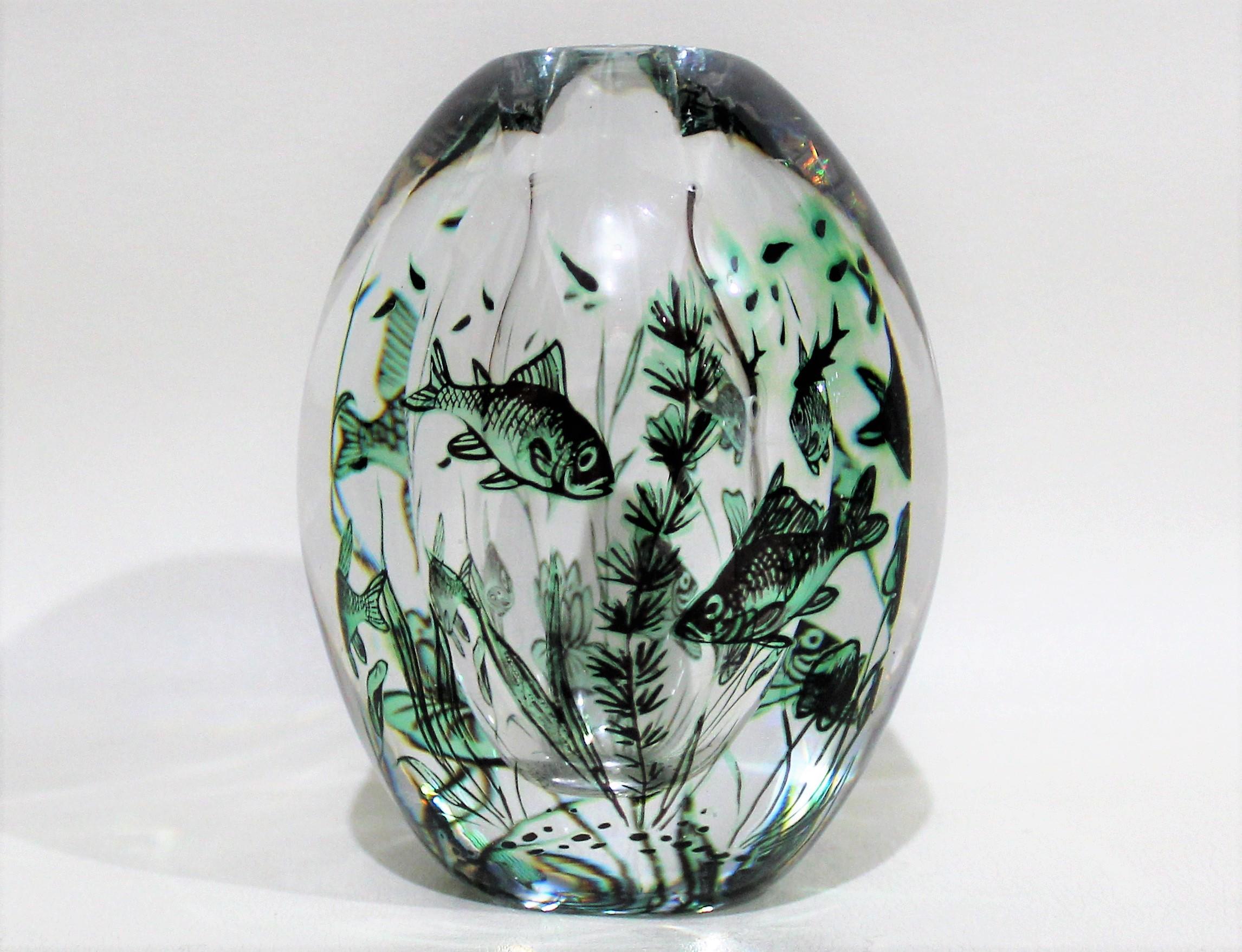 A vintage glass vase, rendered using the 'graal' technique (twice-blown), with depictions of floating fish among seaweed. Produced circa 1950s by artist Edward Hald for Orrefors of Sweden. The maker's mark and artist's signature are etched on the