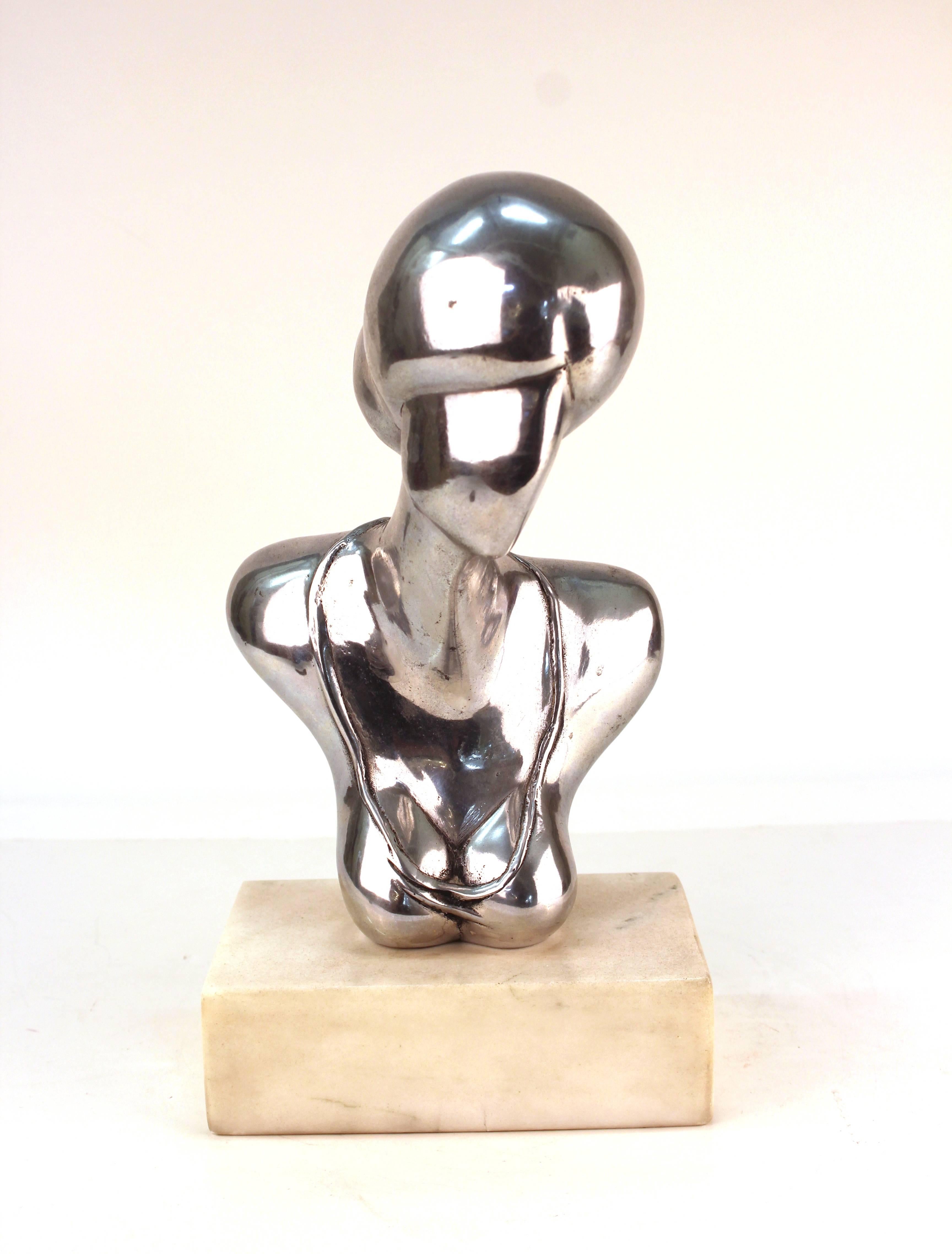A nickel-plated bronze sculpture by Edward J. Walsh (b. 1944, American) of a female bust atop a white marble base. Signed [EWJ] and numbered on the back. The piece is from the 1970s and is in good vintage condition.