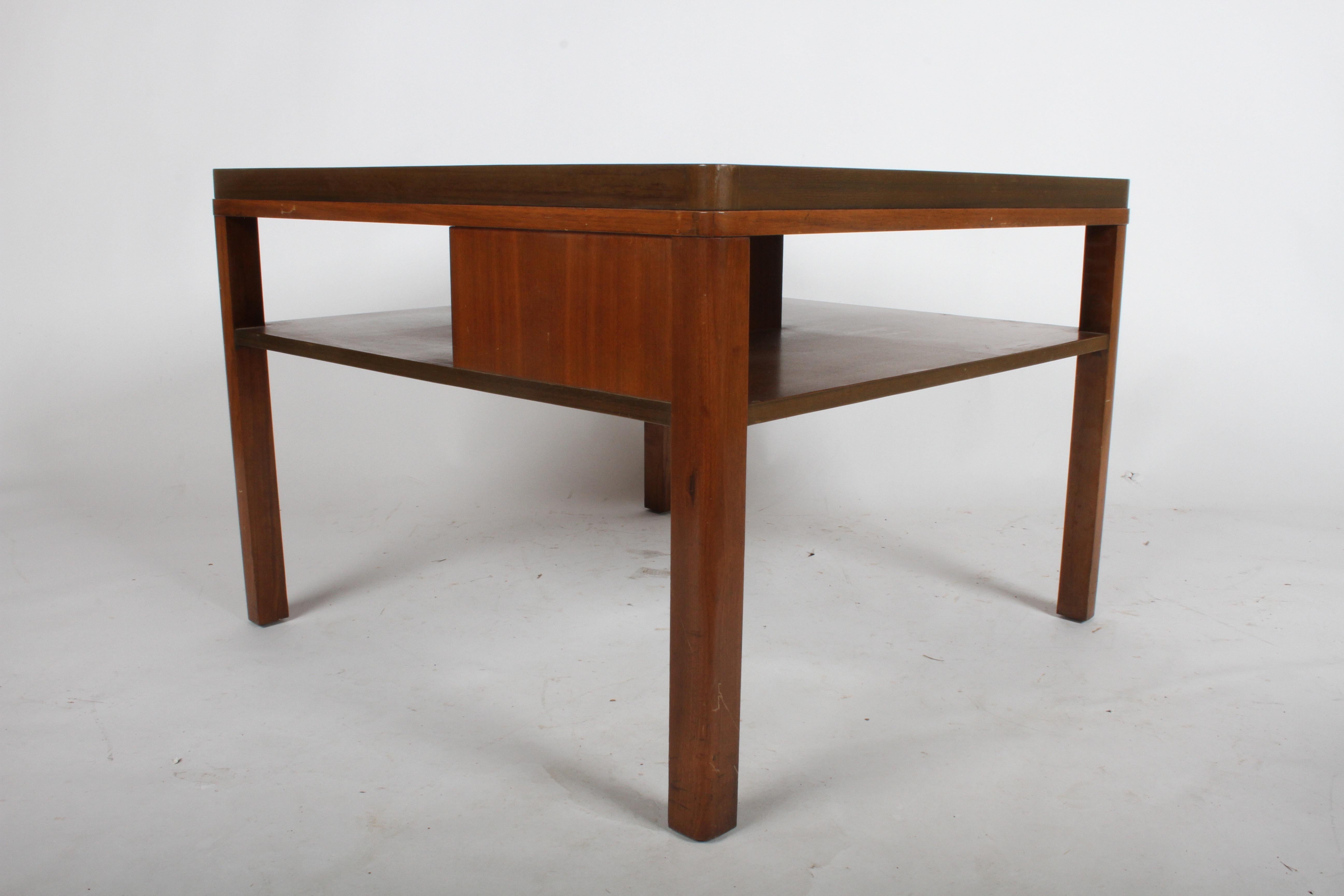 From the 1940s Dunbar Enduring Modern catalog is model # 2193, a single large end table with lower tier bookshelf by Edward J. Wormley. Rounded legs, has divider in center to hold books in place. Original Mahogany frame to be refinished prior to