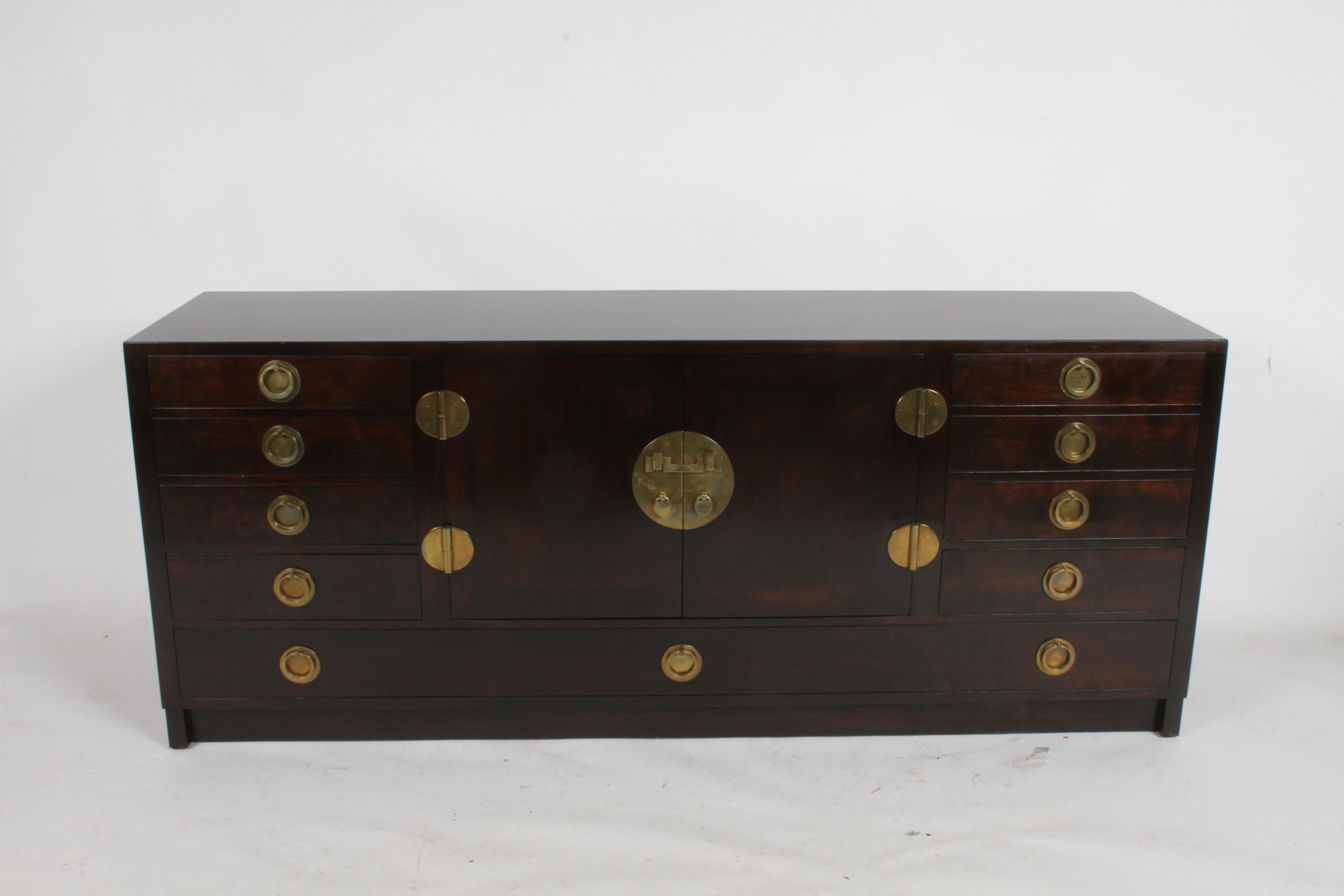 Mid-Century Modern Edward J. Wormley for Dunbar Asian inspired sideboard model # 4579. Mahogany with original dark finish that has been restored, has impressive heavy brass hardware that was imported by Dunbar for authenticity, as noted in Dunbar