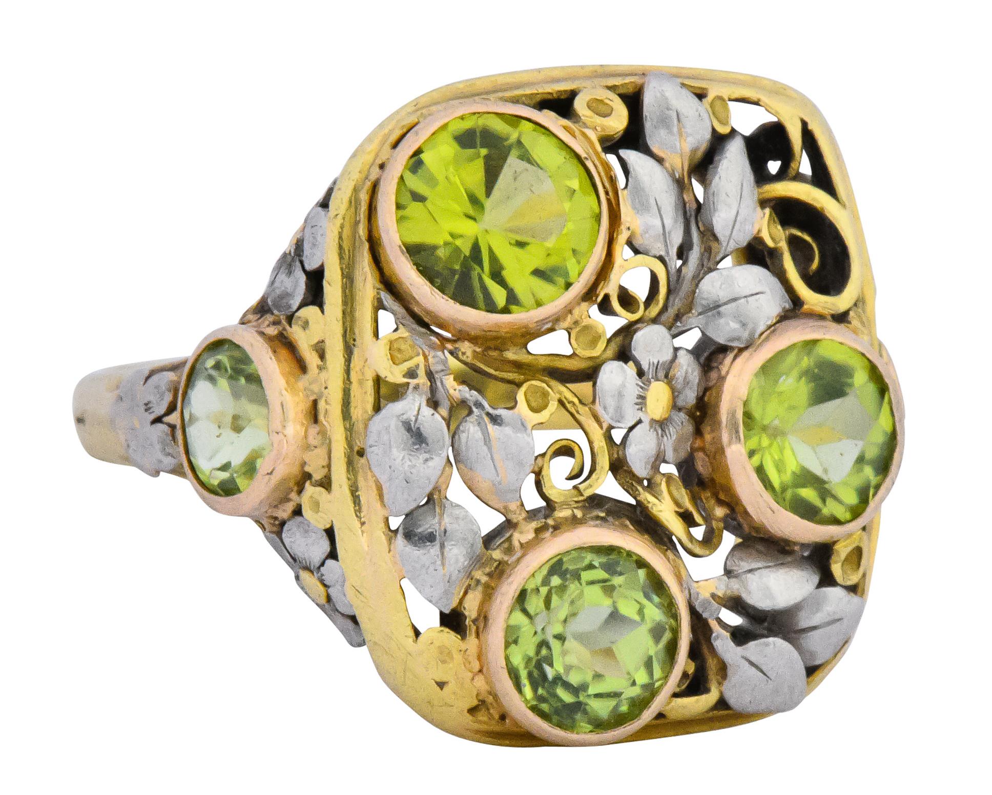 Yellow gold rectangular pierced design with white gold florals and foliate that continue onto shoulders

With five round cut peridot, bezel set in rose gold, weighing approximately 2.15 carats total, vibrant yellowish-green in color

Tested as 18