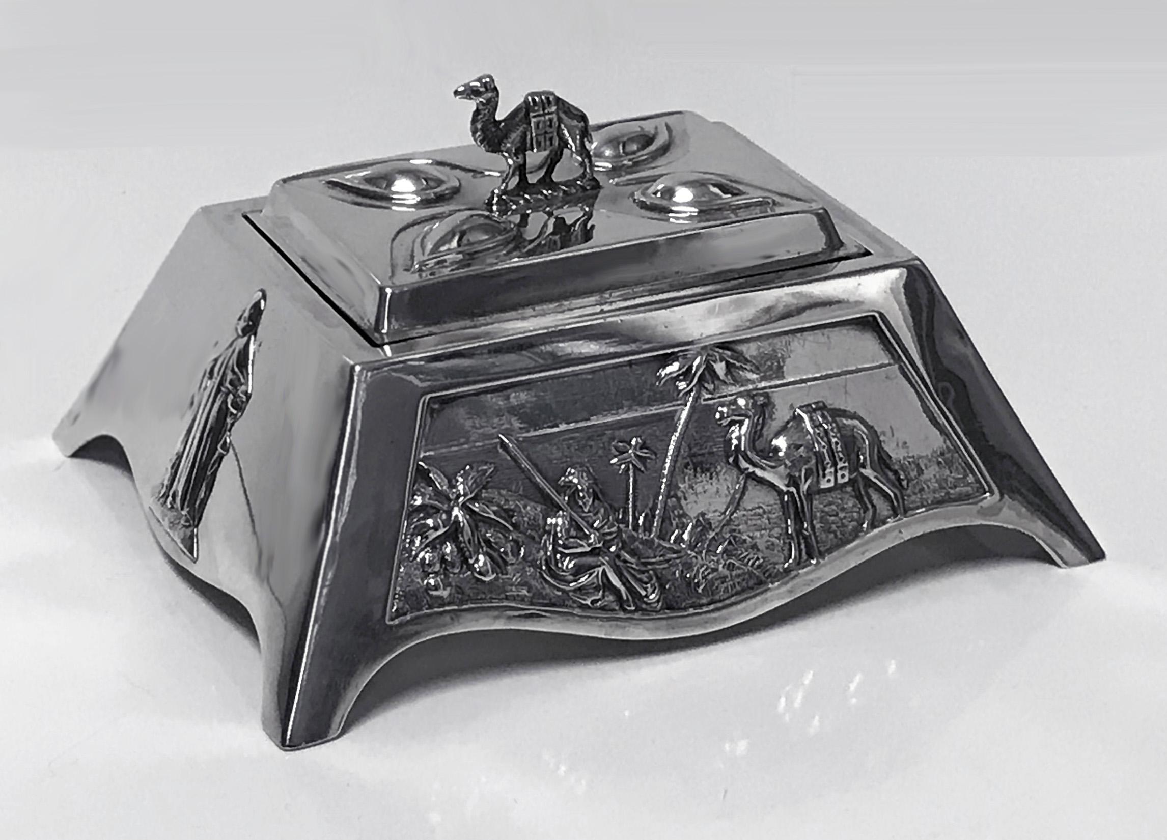 Edward VII 1901 coronation silver box decorated with Arabian scenes with camels, robed figure and Edward V11 Coronet above crossed swords. Hallmarked for Mappin & Webb, London, 1901. Measures: 5.00 x 4.25 x 2.50 inches. Weight: 165.43 grams.