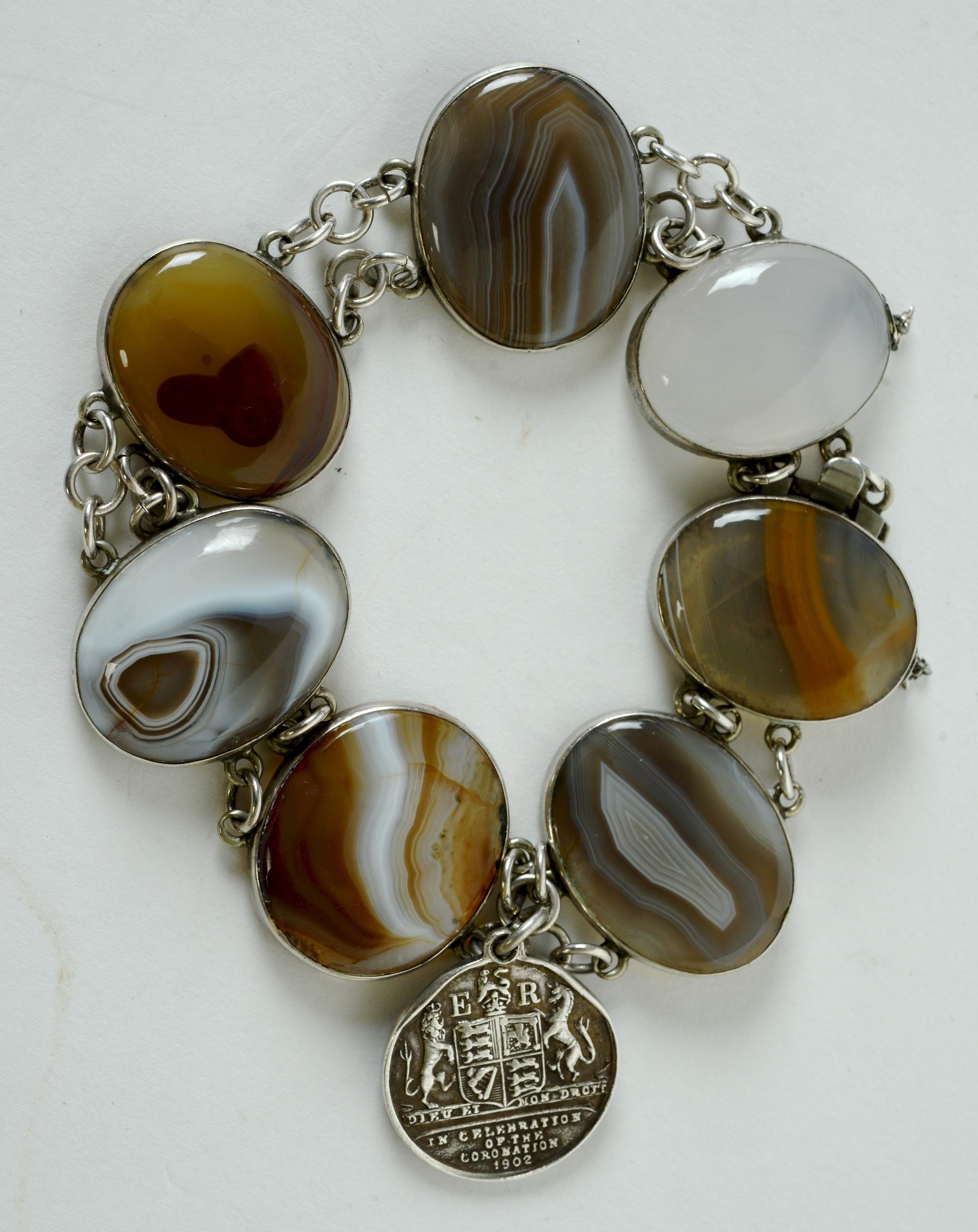 Edward VII and Queen Alexandra Coronation Souvenir Silver Bracelet with Bezel Set Cabochon Shaped Botswana Gemstone Agate Ovals. Each piece of polished agate has a different color and internal markings. The bracelet has a silver medal pendant with