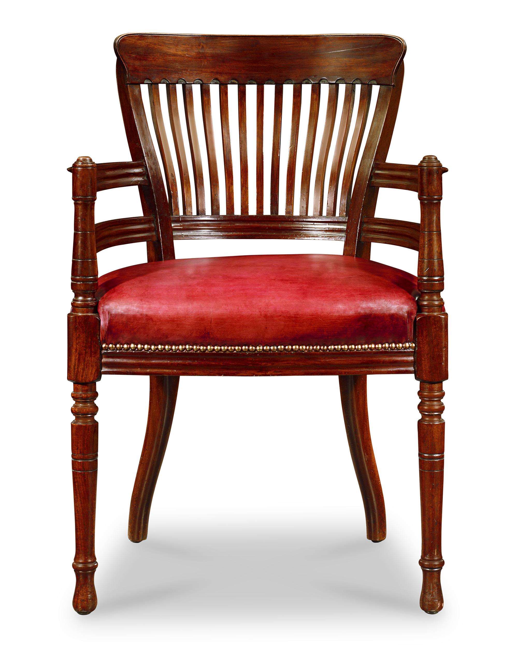 This handsome mahogany desk chair was crafted by progressive English architect-designer Edward William Godwin. The chair reflects the design tenets of the Aesthetic Movement and the nascent beginnings of the Arts and Crafts movement. Punctuated by