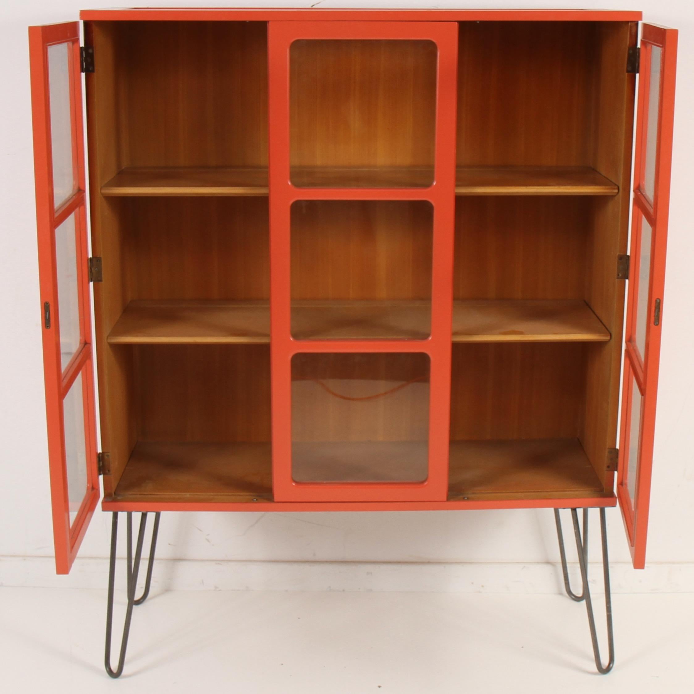 A clean vintage piece re-invented for another generation. Lacquered in orange and given a new lease on life as a bookcase on sturdy hairpin legs. 

Edward Wormley (1907-1995) created many Classic furniture designs throughout the 1940s, 1950s, and