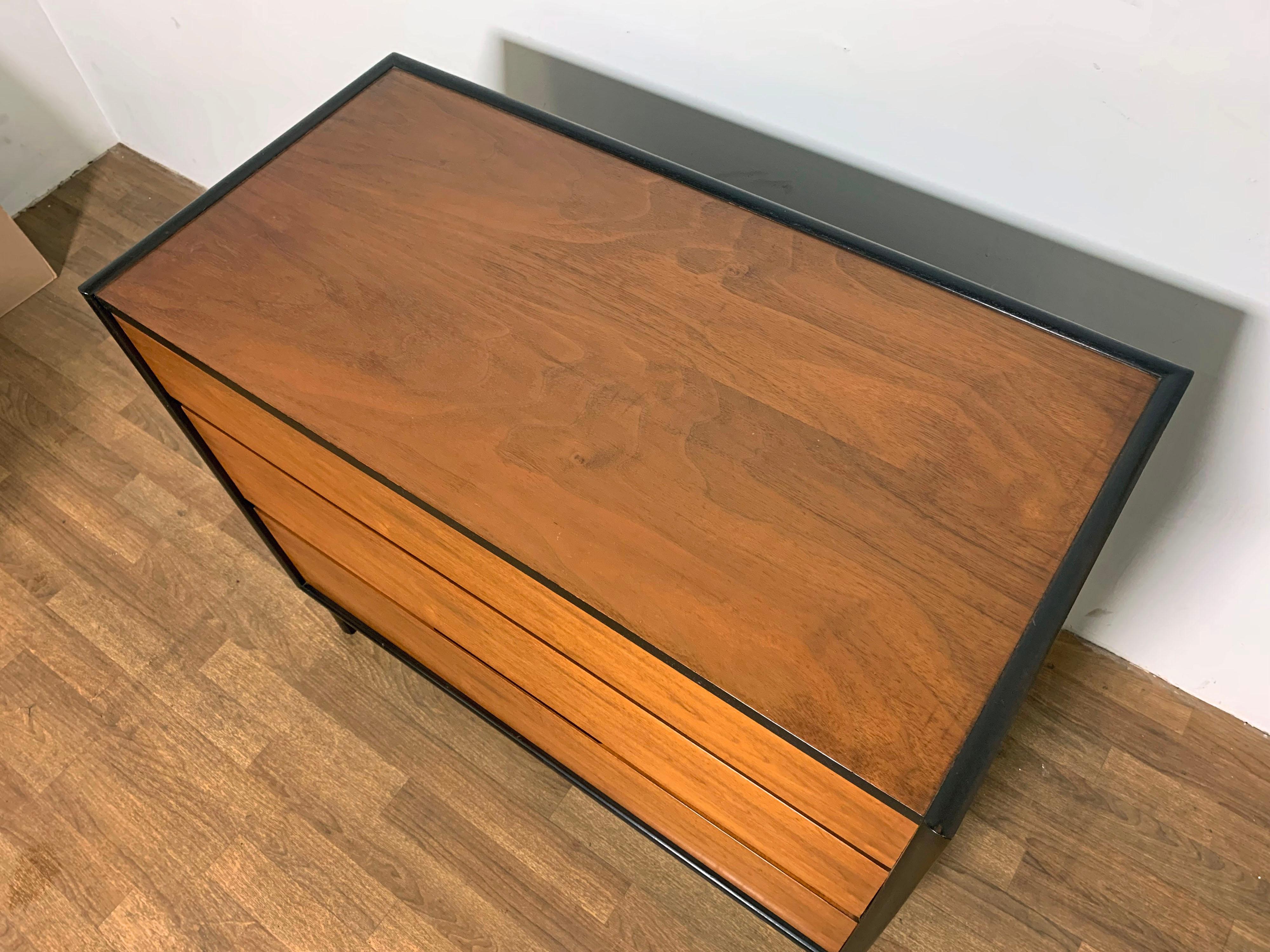 Three drawer dresser by Edward Wormley for Dunbar with two-tone contrasting Honduran mahogany drawer fronts, top and sides, and rosewood trimmed case, circa 1960s.
