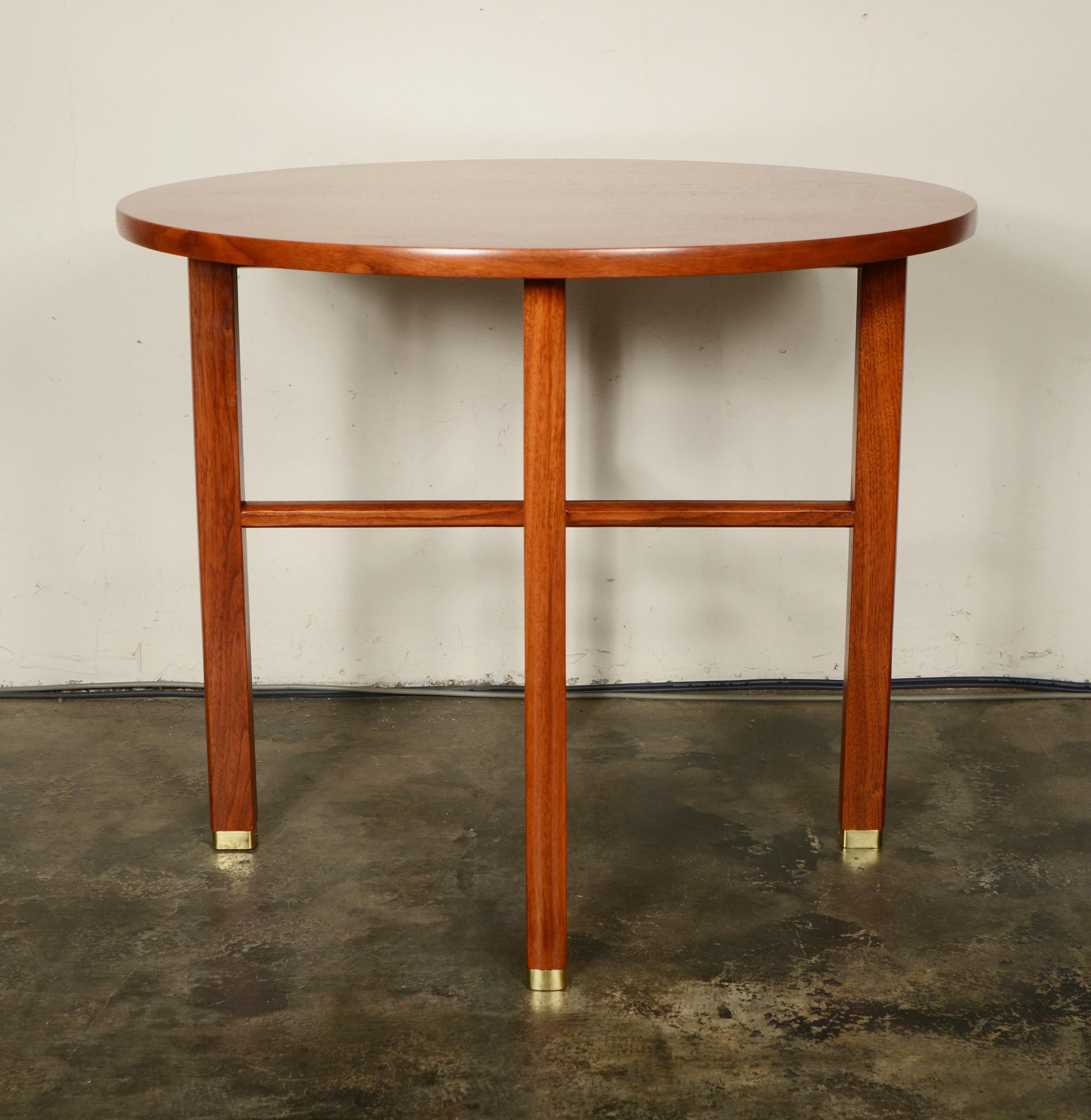 Walnut X stretcher side table designed by Edward Wormley. The legs have brass sabots. Classic clean lines and outstanding grain. The table is refinished.