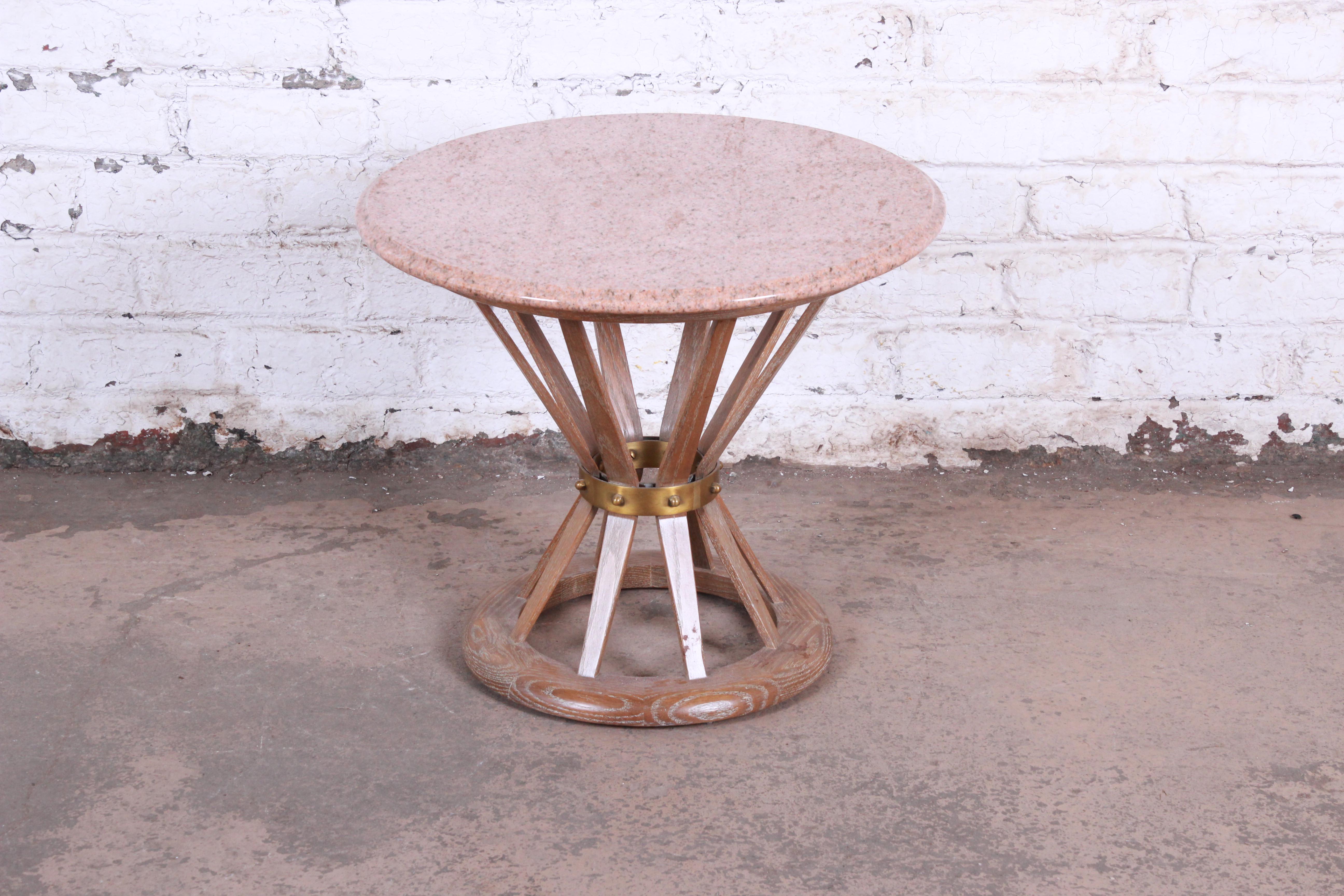 A gorgeous Mid-Century Modern sheaf of white side table in the manner of Edward Wormley for Dunbar. The table features a sculpted cerused oak base in sheaf of wheat form, with brass band and stunning beveled pink marble tops with white and black