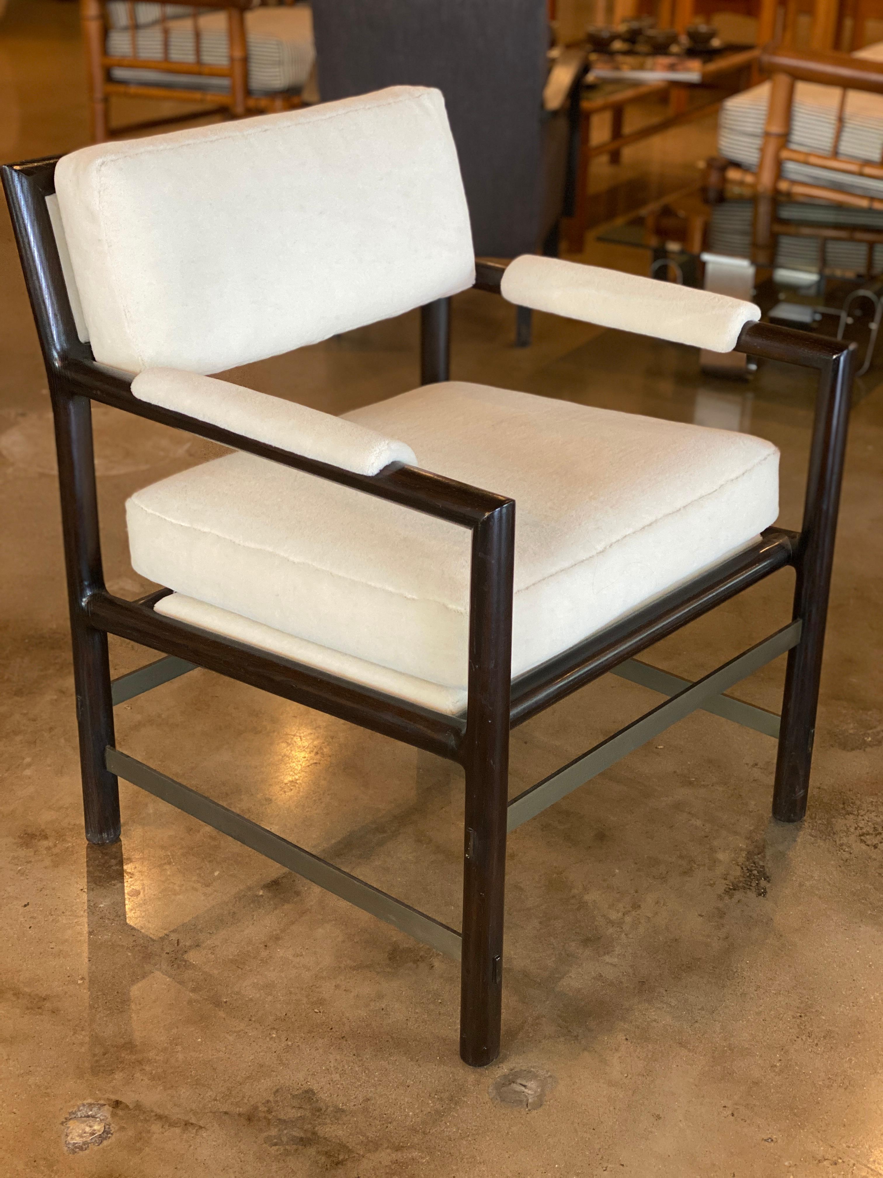 Pair of Edward Wormley for Dunbar armchairs. Solid ash frames with ebony finish are held by solid bronze stretchers. Frame finish has been professionally touched up and the fabric has been newly upholstered in luxuriously soft off-white mohair.