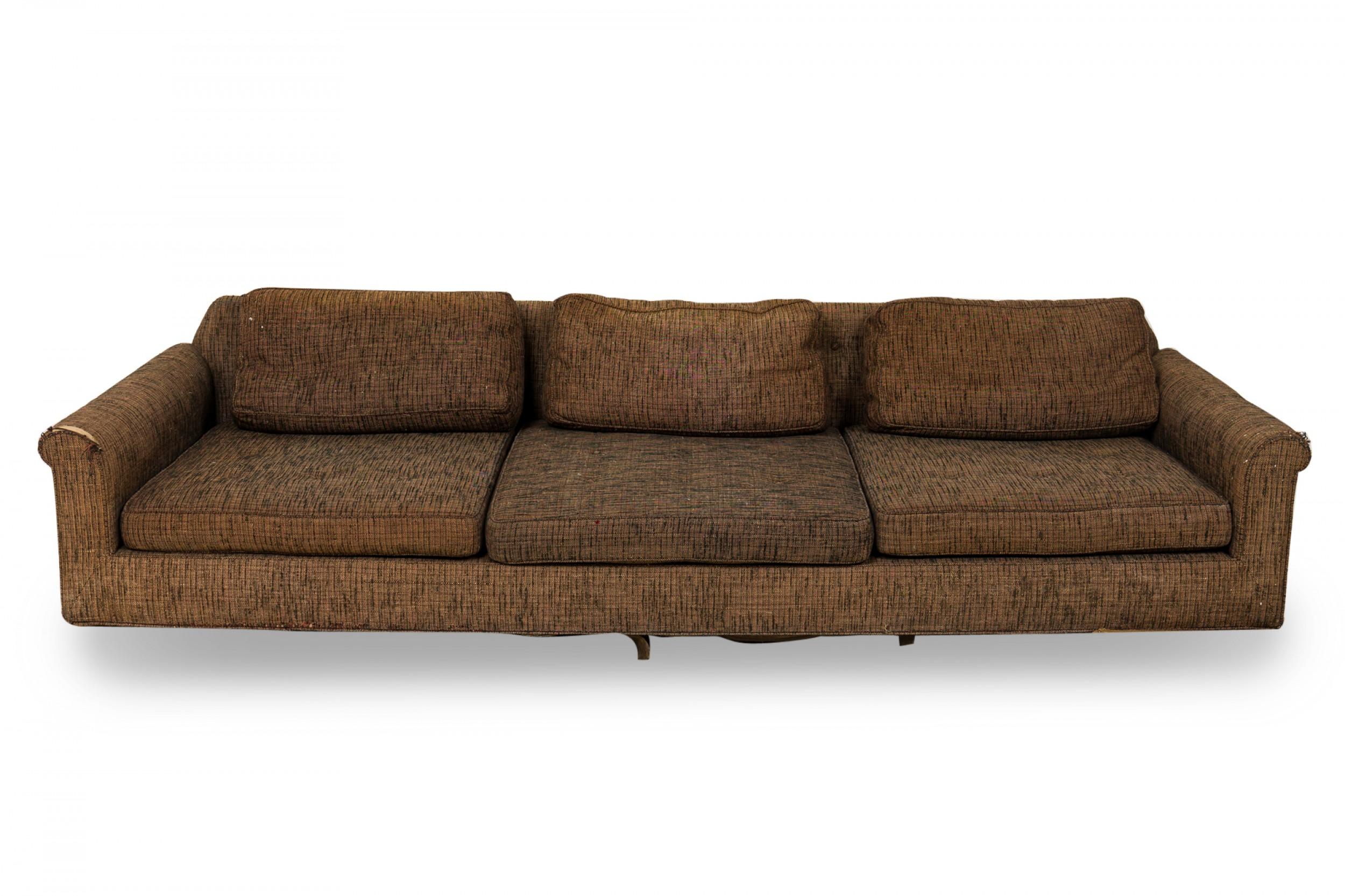 American Mid-Century 'Big Texan' oversized sofa with brown textured fabric upholstery and removable seat and back cushions. (EDWARD WORMLEY)
