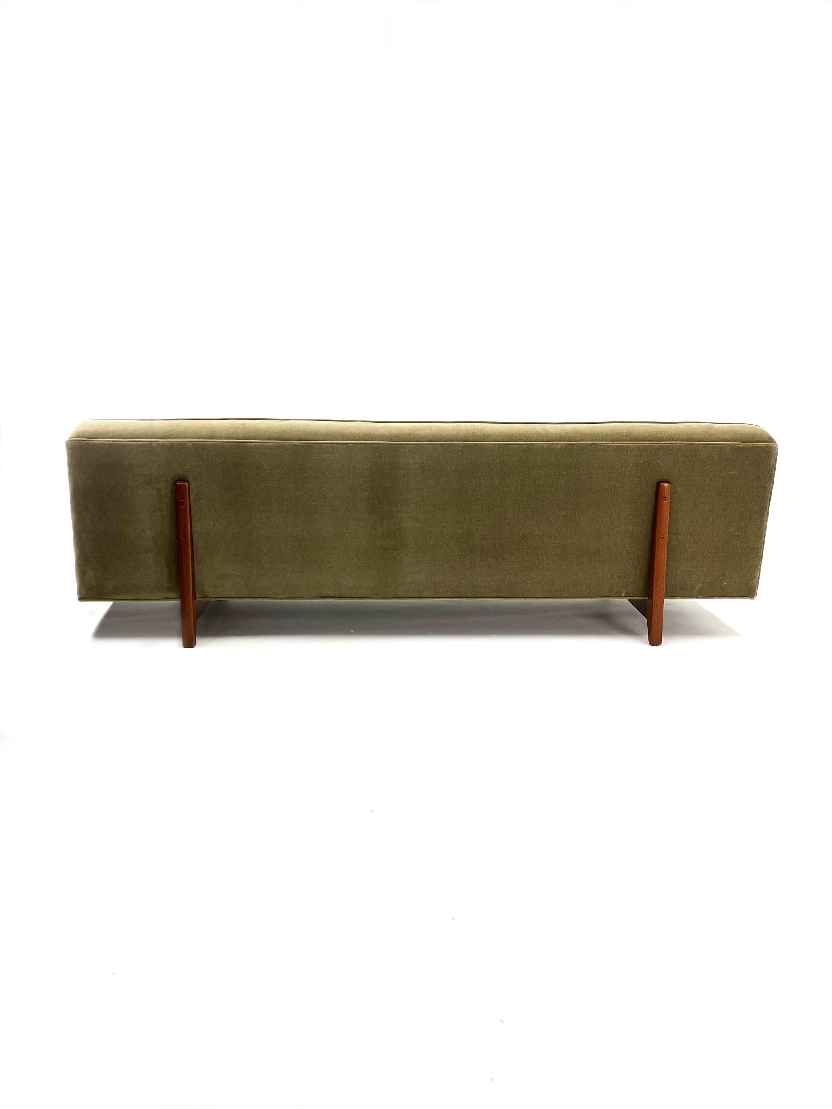 Introducing the newly upholstered and freshly-restored bracket-back three seater sofa by Edward Wormley for Dunbar. This comfy Mid Century Modern sofa features mahogany legs that run from the base and up the back of the sofa giving it an appearance