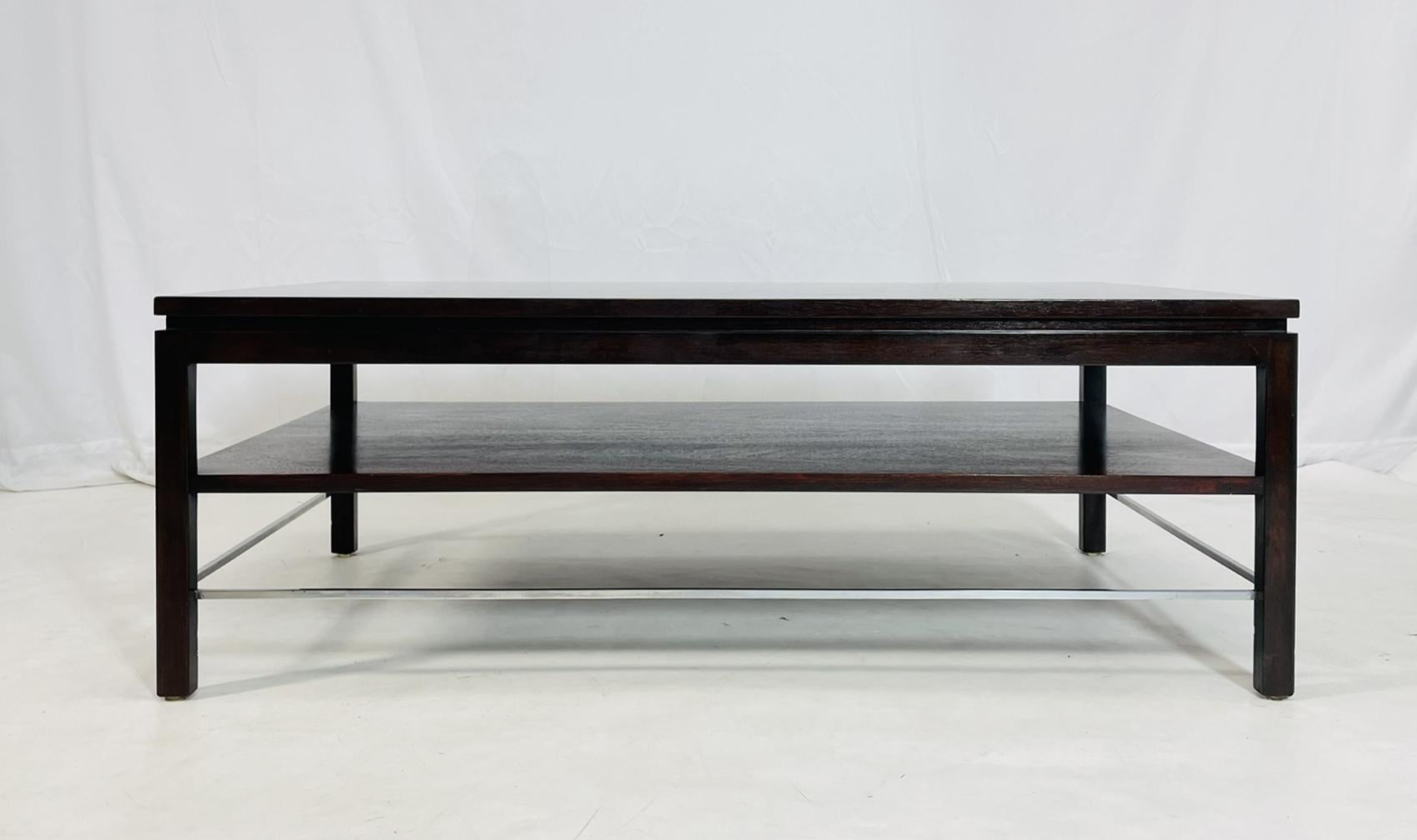 An exquisite coffee table designed by the renowned Edward Wormley for Dunbar dates back to the 1950s. This stunning piece showcases a harmonious blend of walnut and mahogany, reflecting Wormley's signature approach to timeless elegance and modern
