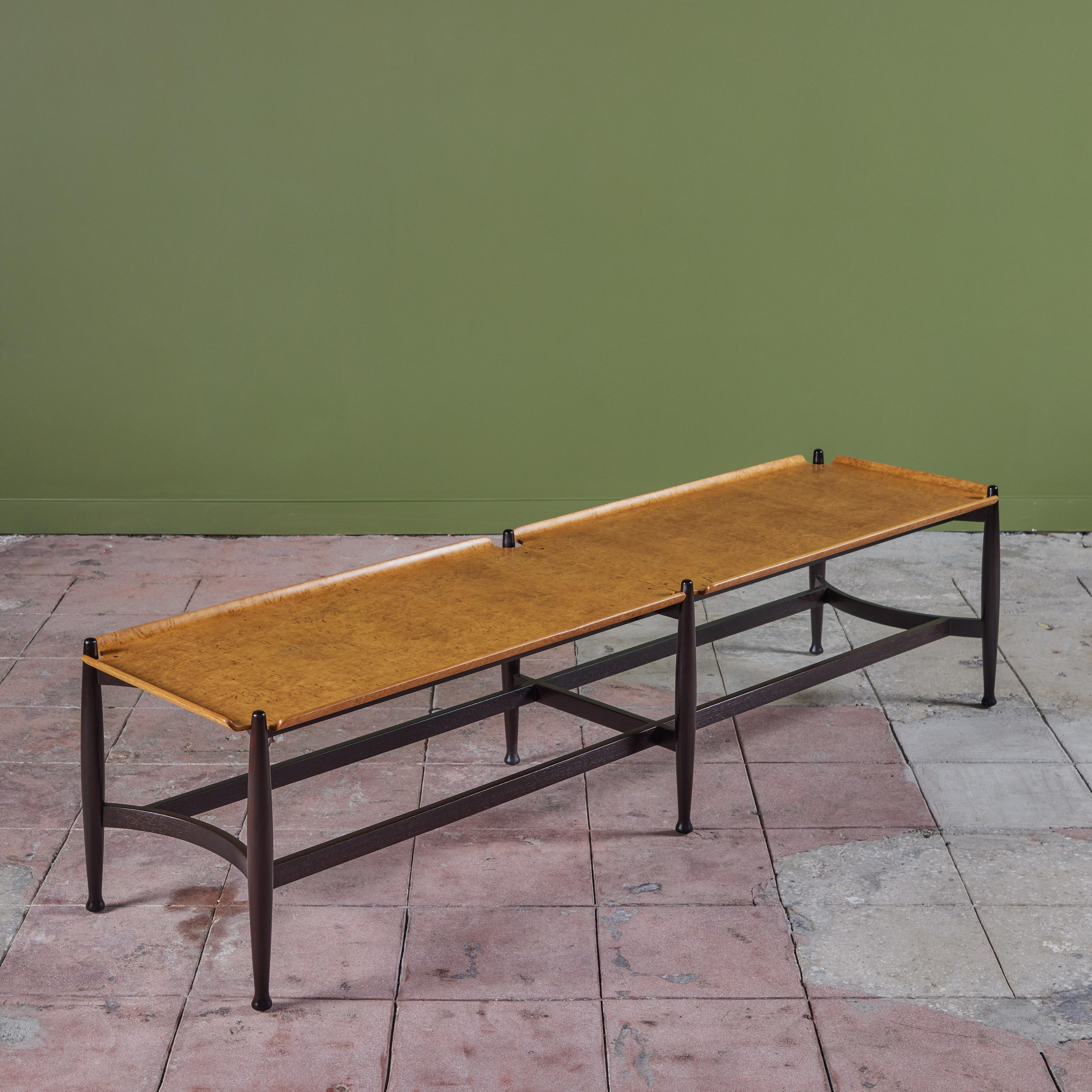Coffee table designed by Edward Wormley for Dunbar, c.1950s, USA. The rectangular table features an ebonized base with six turned wood legs and stretchers that reach the length of the table. The maple burl tray table top has slightly raised edges
