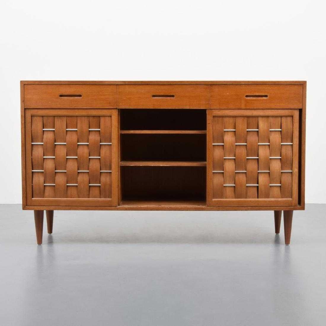 Cabinet by Edward Wormley for Dunbar. Cabinet is model 5665 and has three upper drawers with dividers. One door reveals three pull-out drawers and storage, the middle drawer with two adjustable shelves and the other door has three pull-out drawers