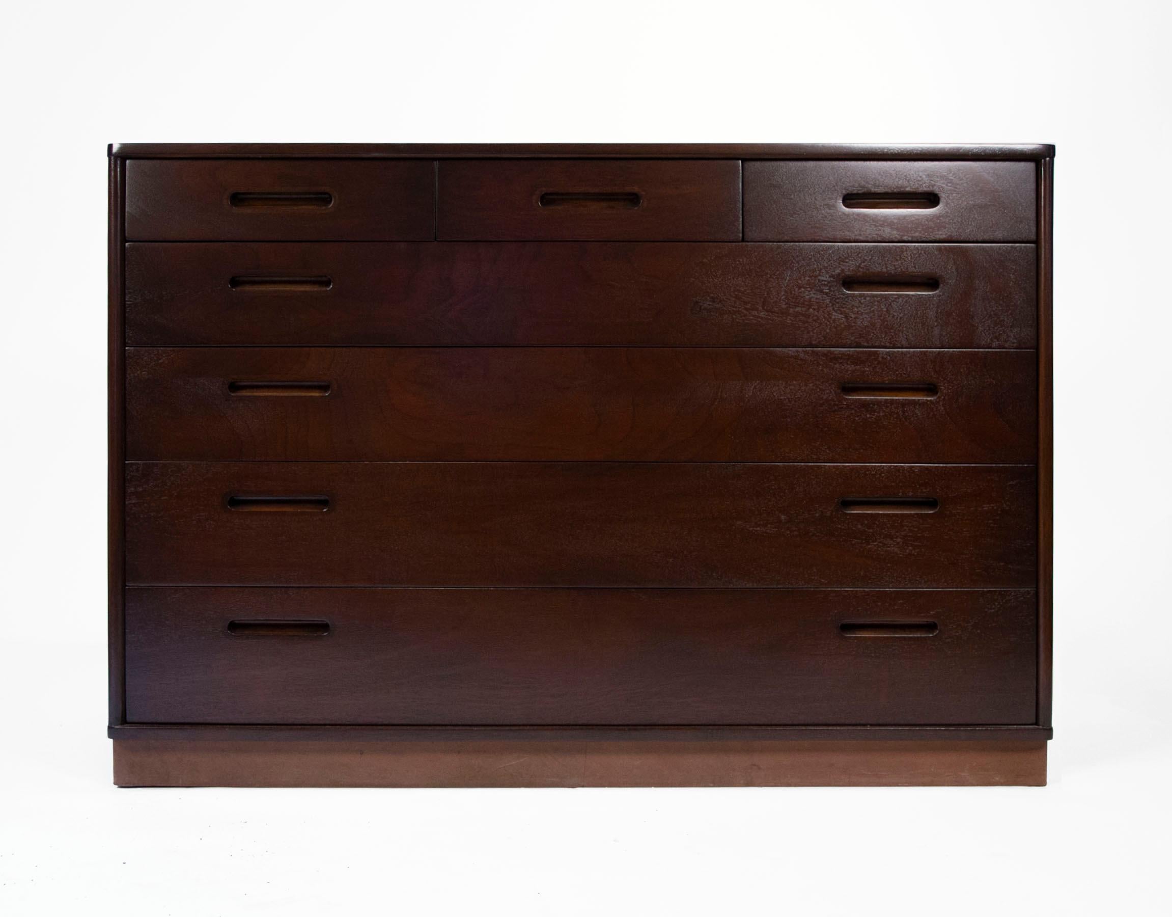 Pair of six drawer bachelor chests with inset hardware designed by Edward Wormley for Dunbar in a dark espresso stain with a clear satin lacquer finish and leather plinth bases. Solid Oak interiors. 

These would serve well as oversized