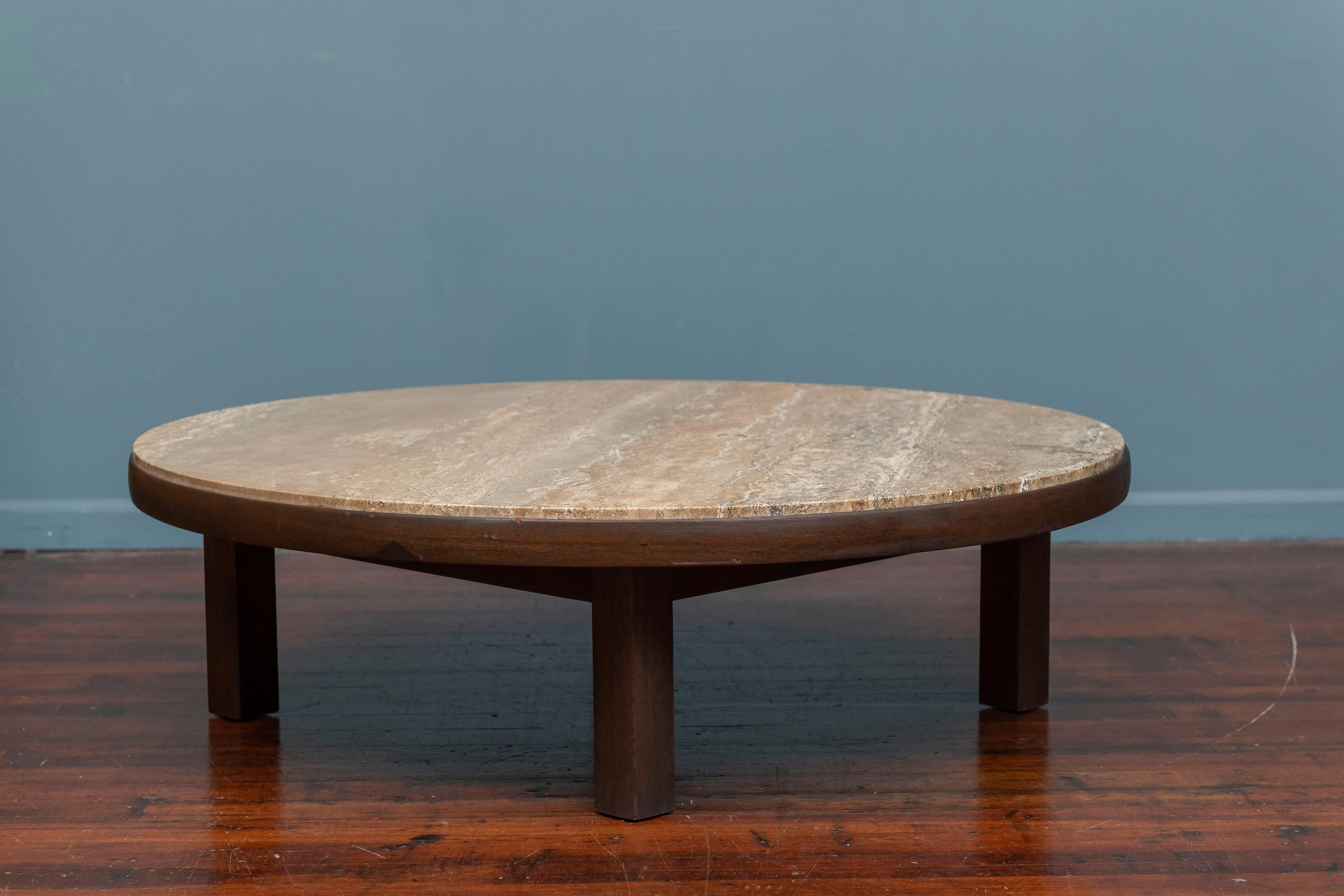 Edward Wormley design coffee table for Dunbar Furniture, Berne Indiana. Large and impressive table with a beautiful travertine stone top on a shaped round dark walnut frame on four block legs, labeled.