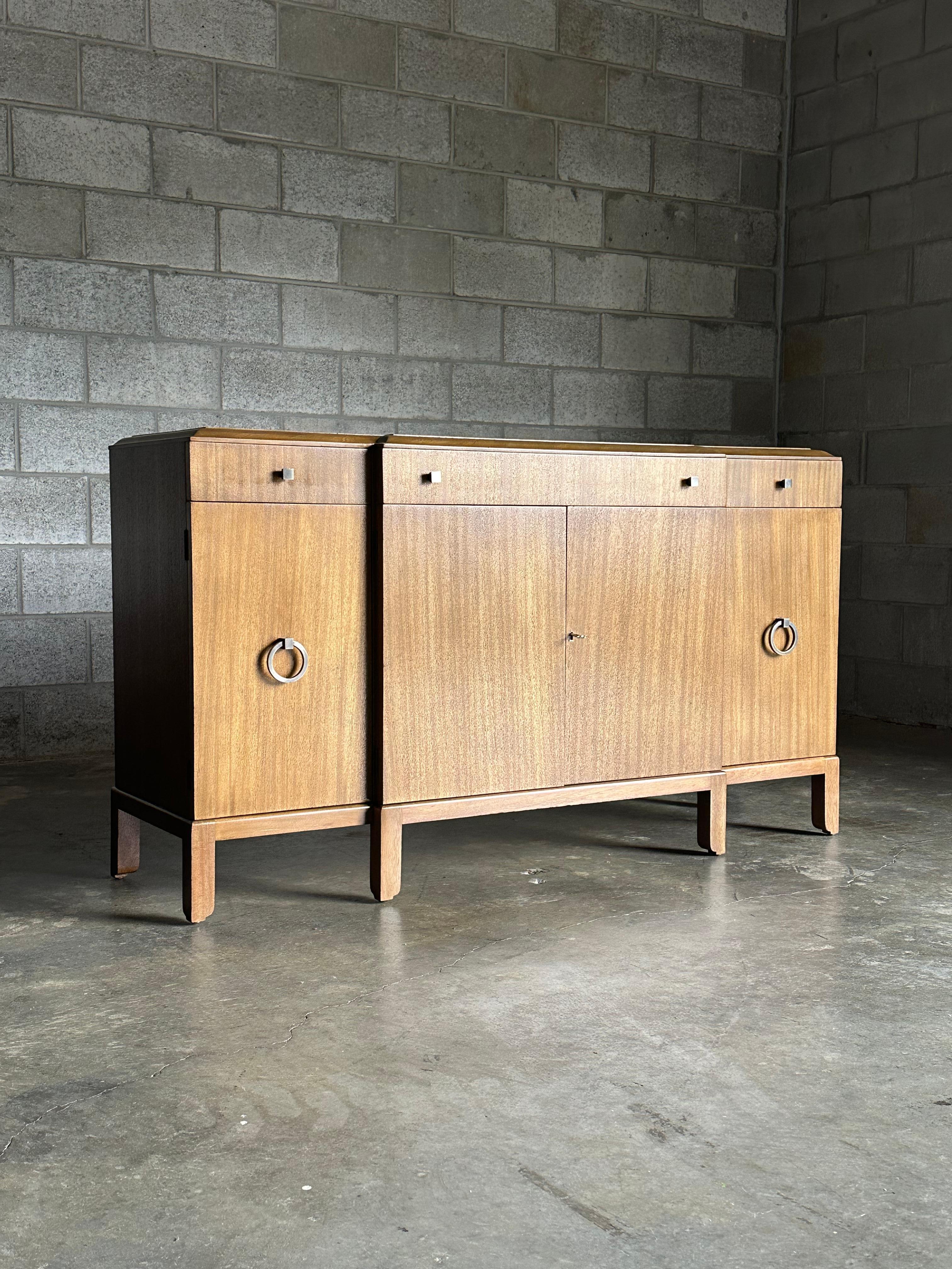 A very early (late 1930s- early 1940s) sideboard designed by Edward Wormley for Dunbar. This piece is a testament to his design philosophy of embracing new and holding onto what is true- this sideboard is no exception; it blends a traditional and