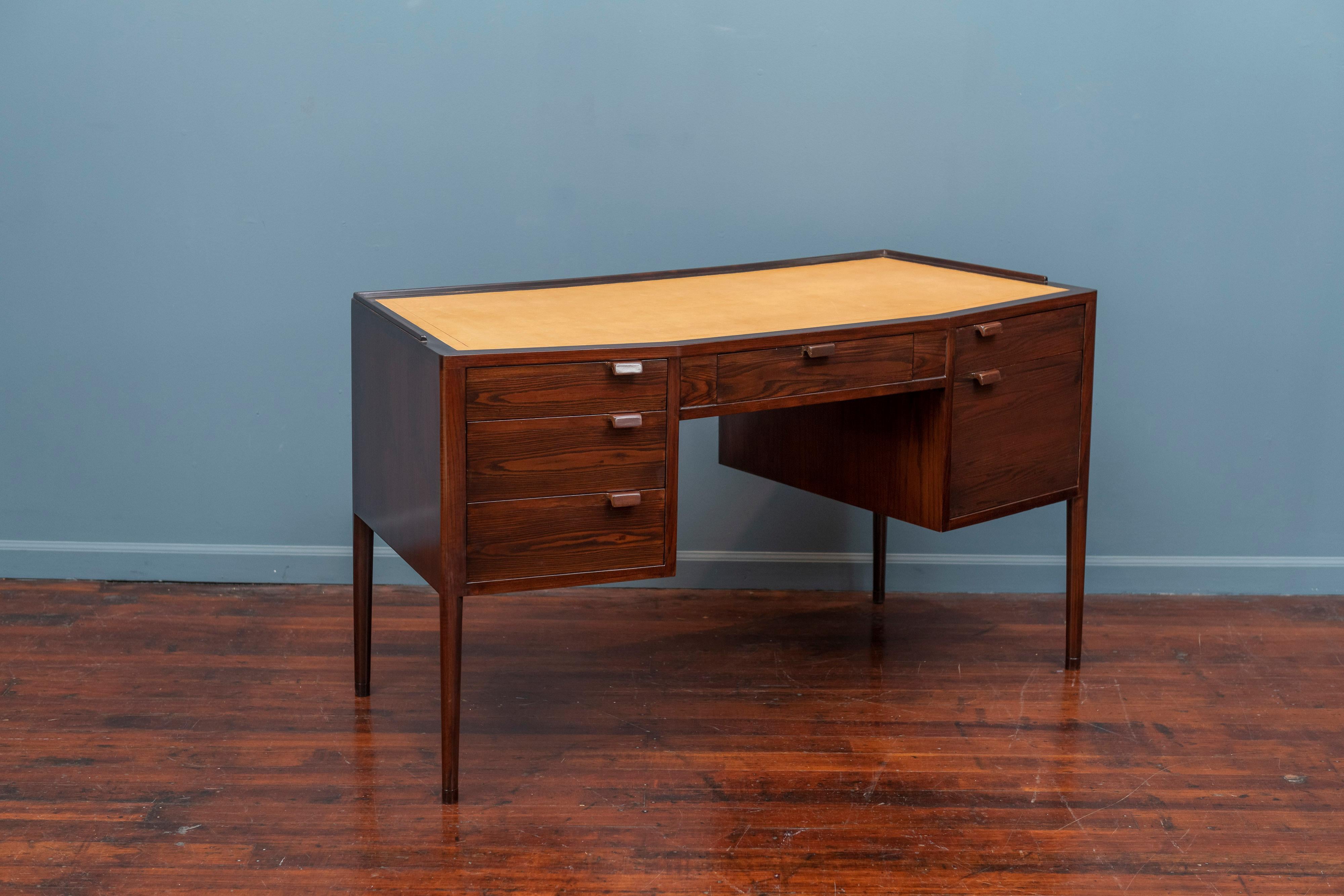 Edward Wormley design six drawer desk for Dunbar, Berne Indiana. Newly refinished with a mustard leather top, gallery edge border and smooth gliding drawers, labeled.
Together with an associated Riemerschmid design mahogany armchair with newer