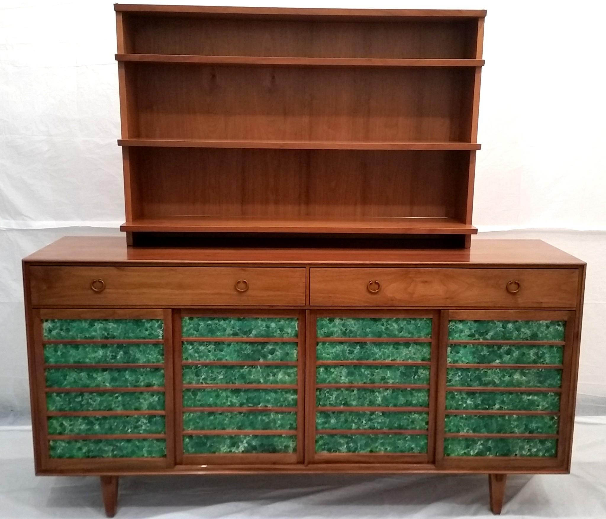 An Edward Wormley designed walnut sideboard manufactured by Dunbar, model 671A, circa 1953 with
An exquisite Japanese inspired cabinet featuring four sliding walnut doors with two drawers with cast bronze pulls. An unusual detail of the sideboard is