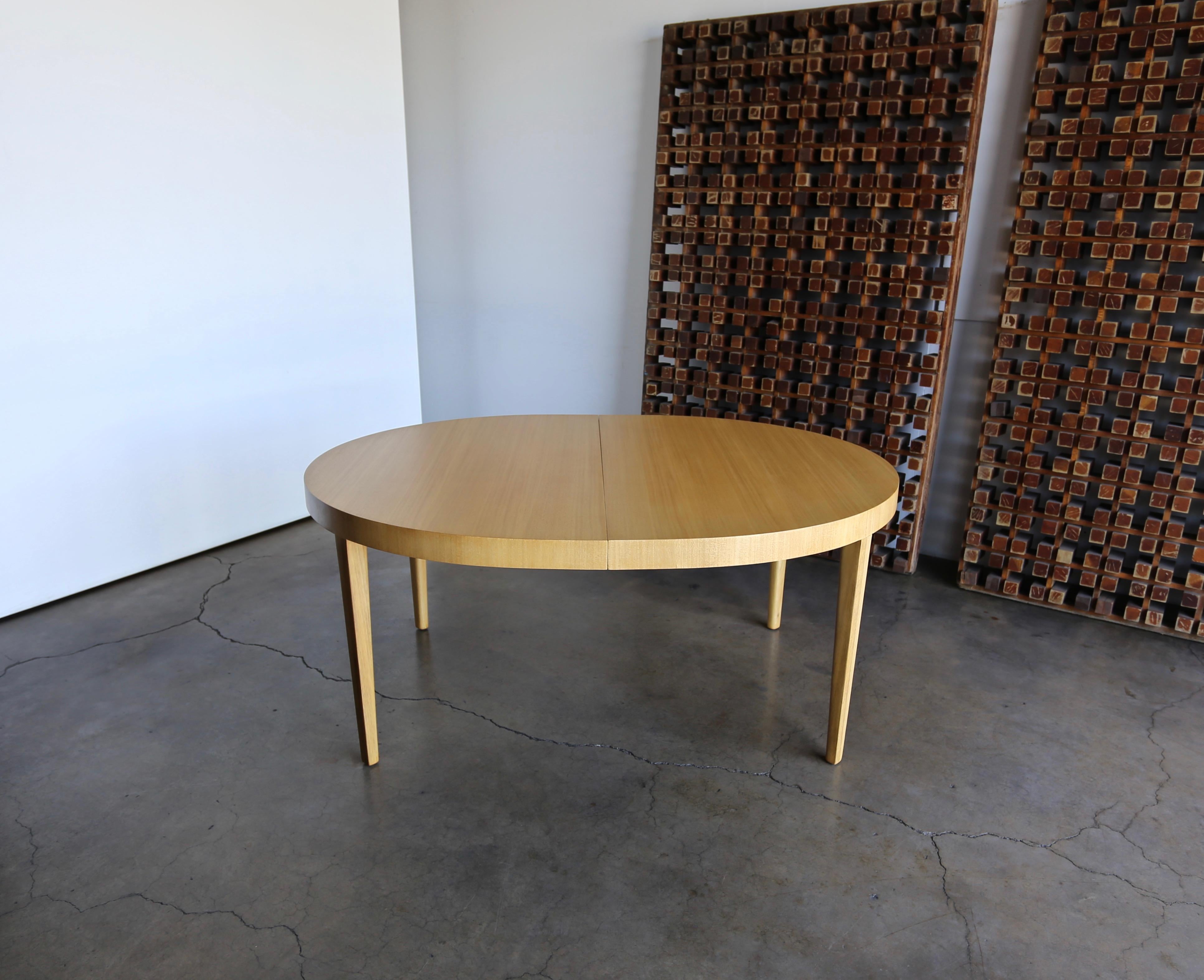 Edward Wormley bleached mahogany dining table for Dunbar, circa 1950. This piece has been professionally restored.

This table extends from 65.75