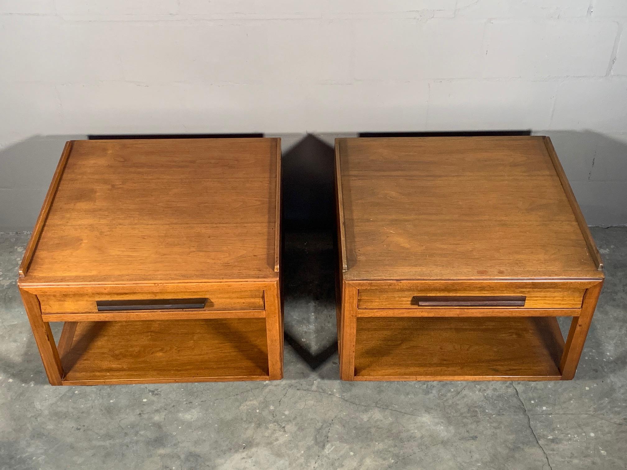 A pair of unusual, large scale #5913B tables, by Edward Wormley for Dunbar. Walnut with rosewood handles, drawer and lower shelf, they have removable casters. Each measures 27
