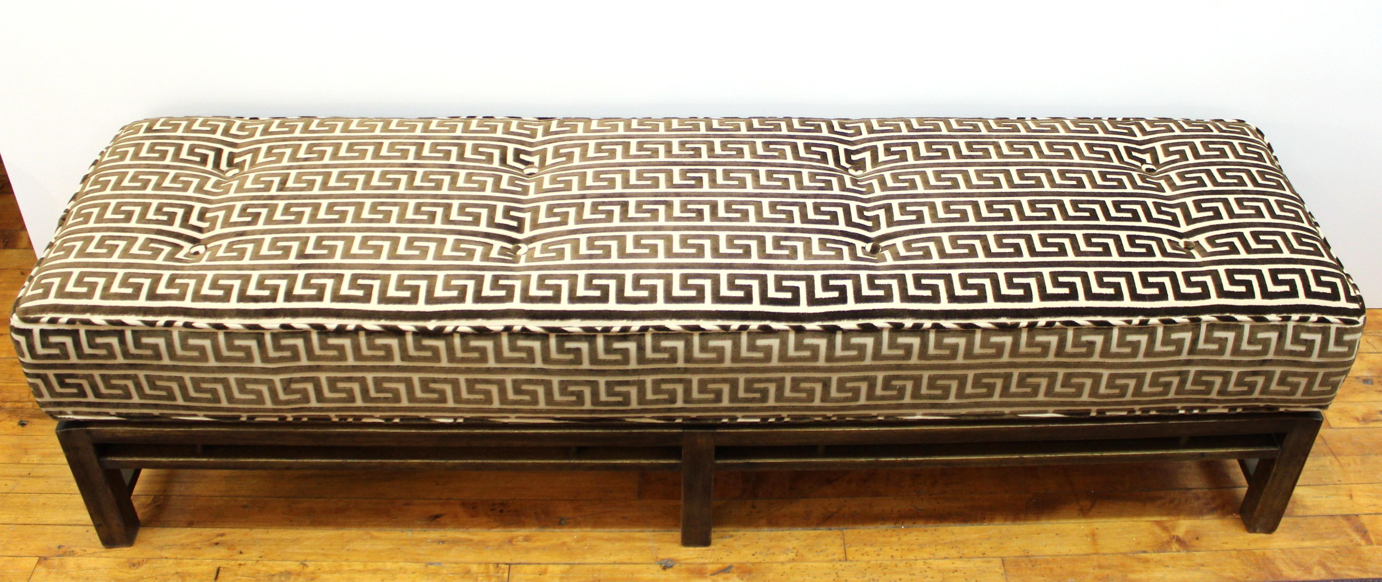 American Mid-Century Modern long walnut bench designed in the 1950s by Edward Wormley for Dunbar. The piece has been newly reupholstered in a Lee Jofa Greek key cut velvet. The piece is in excellent condition.