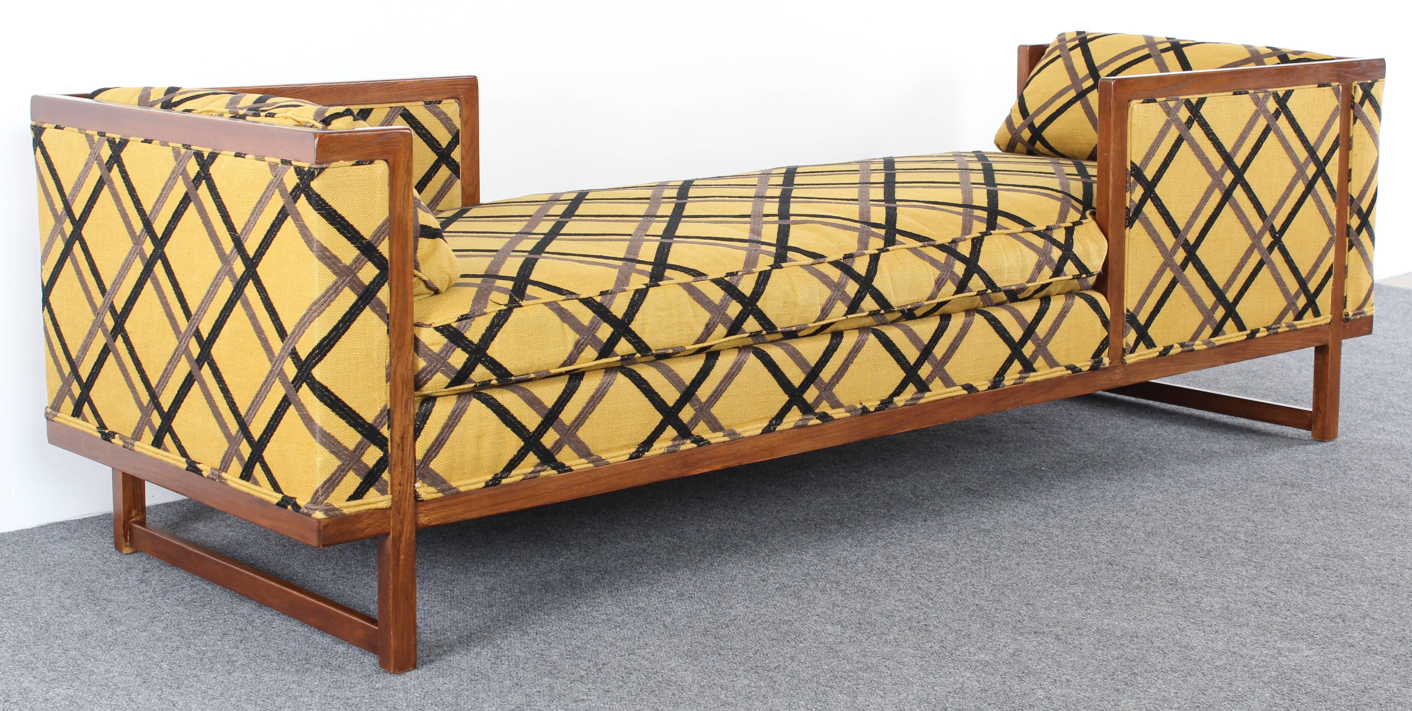 A Tete-A-Tete or daybed in the style of Edward Wormley for Dunbar. Great Mid-Century Modern form with exposed walnut wood structure. New upholstery recommended.