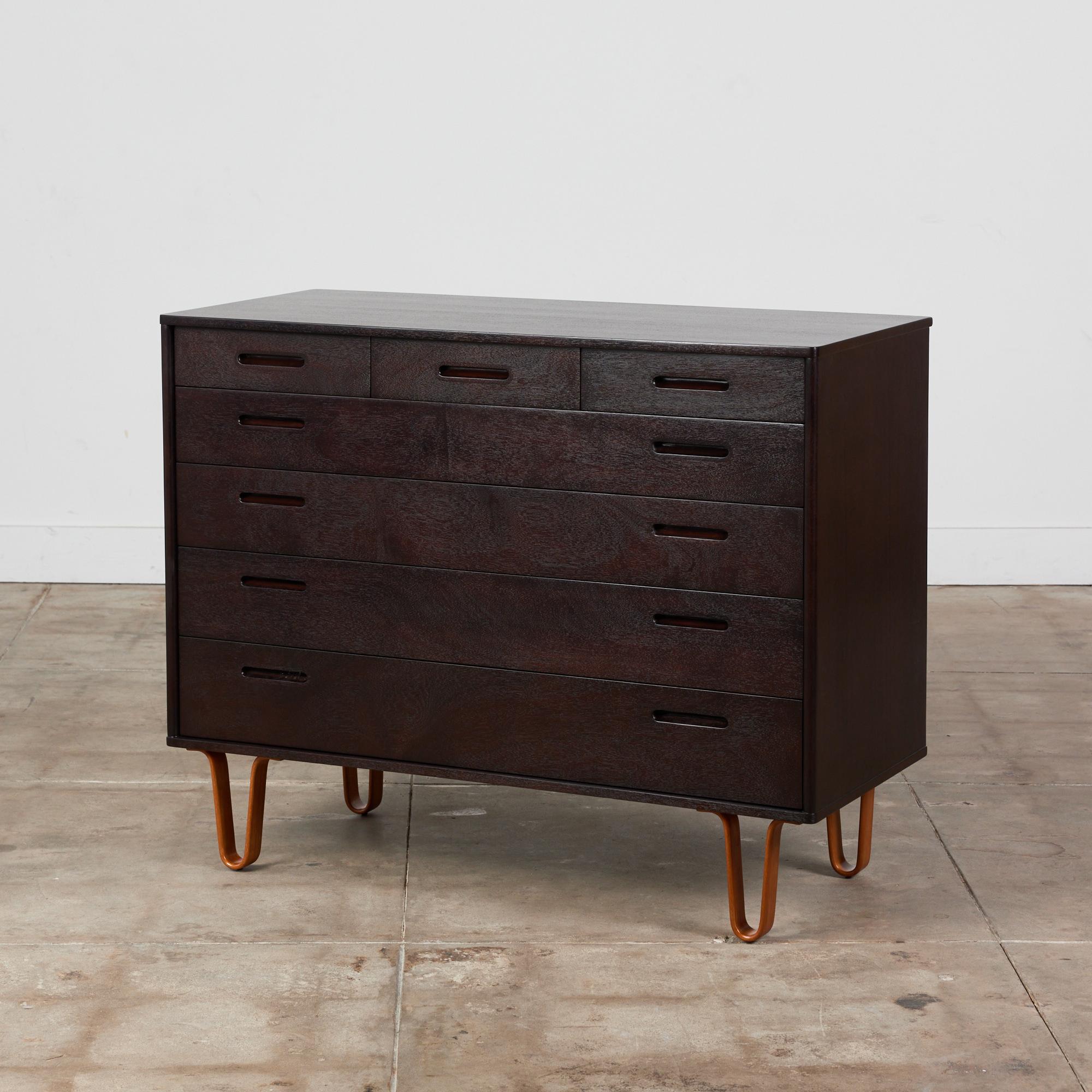 Edward Wormley for Dunbar, c.1970s, USA. The mahogany dresser has been newly refinished and ebonized. It features three smaller drawers along the top of the dresser and four full length draws below. The dresser is supported by four bent mahogany