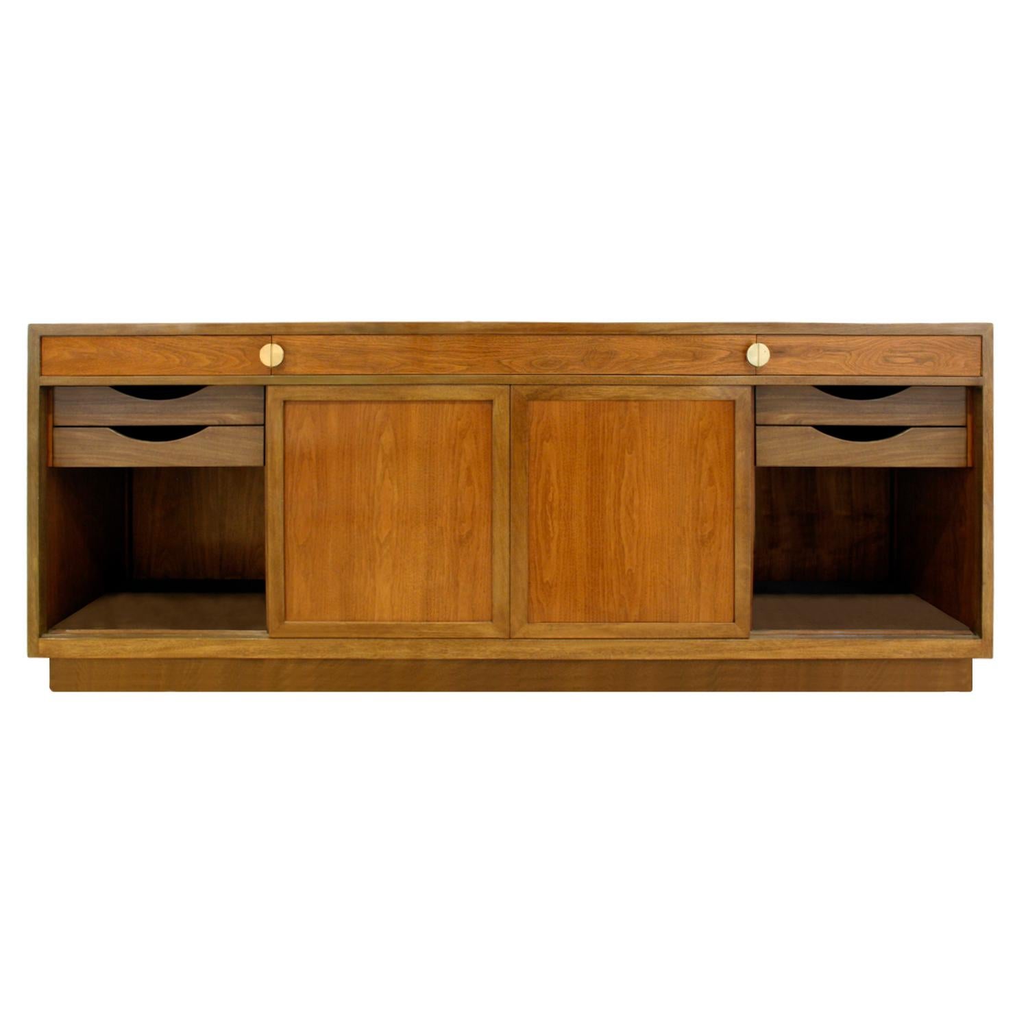 Fine 4 door credenza in mahogany with walnut doors and brass “D” pulls by Edward Wormley for Dunbar, American 1960's (signed in drawer). This piece is beautifully outfitted and meticulously crafted.