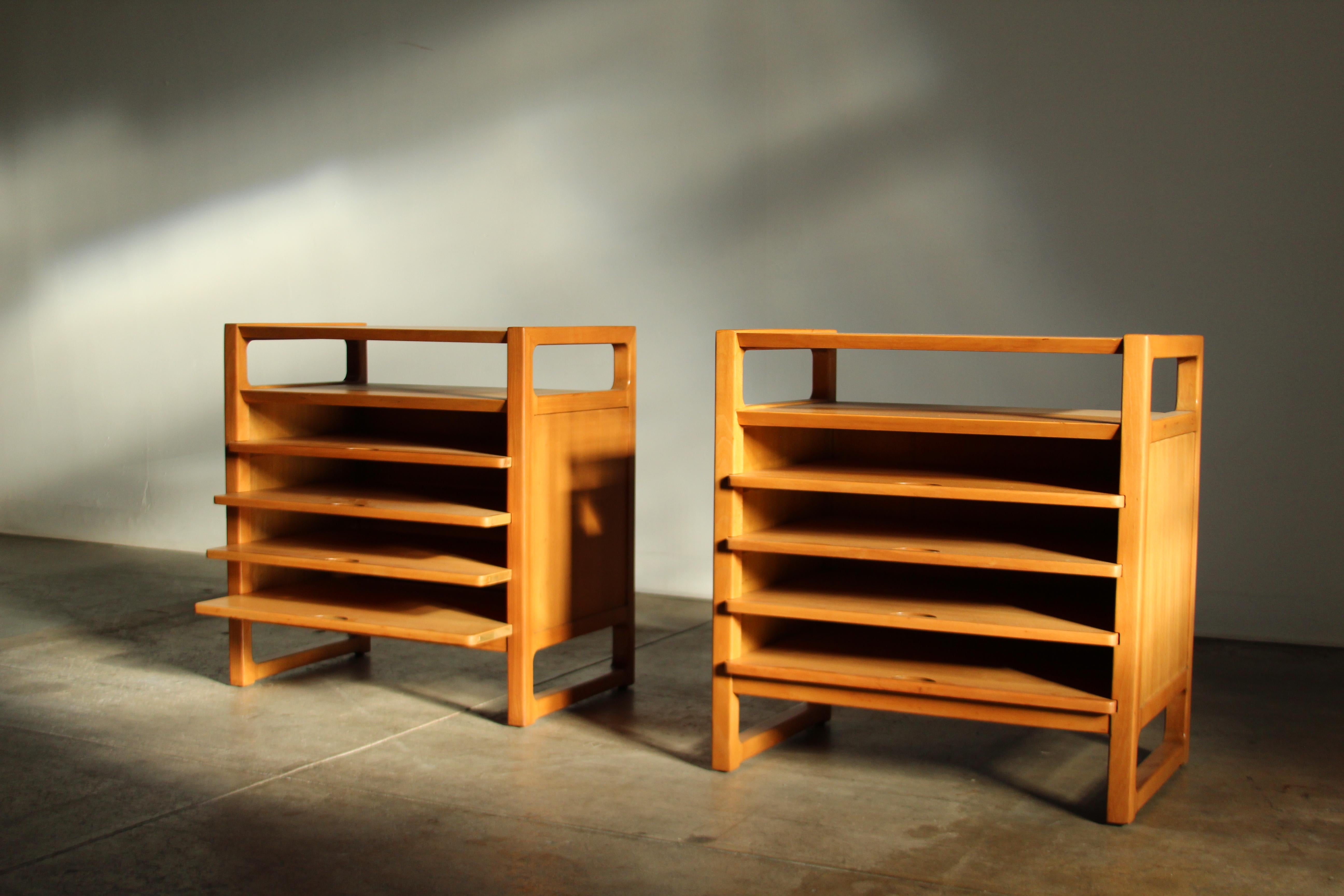 Edward Wormley for Drexel Precedent magazine tables or nightstands in solid Elm. These heavy duty tables each have five shelves, four of which pull out via beautifully carved out finger pulls. These sturdy tables would be perfect beside a bed or