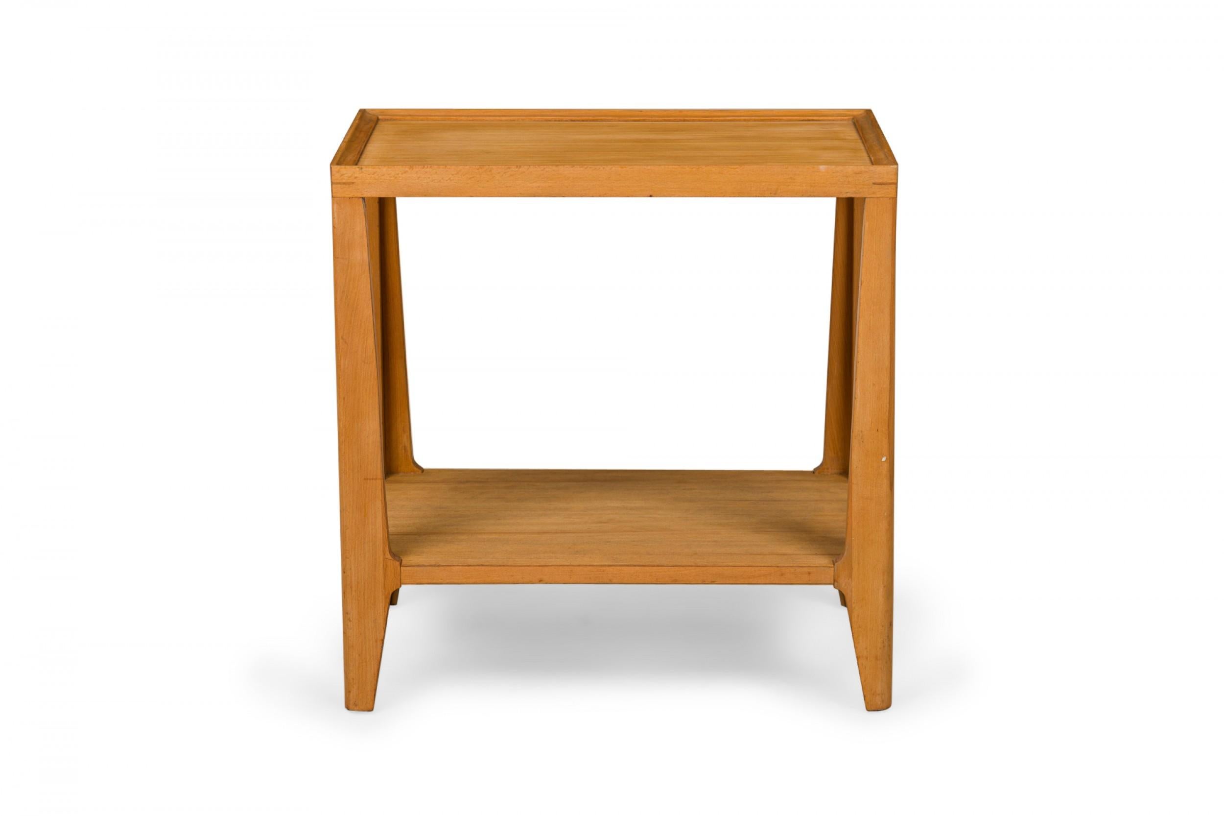 American mid-century rectangular end side table with a rectangular top with a shallow beveled lip and lower stretcher shelf supported by a four-leg frame ending in tapered corner feet. (EDWARD WORMLEY FOR DREXEL)