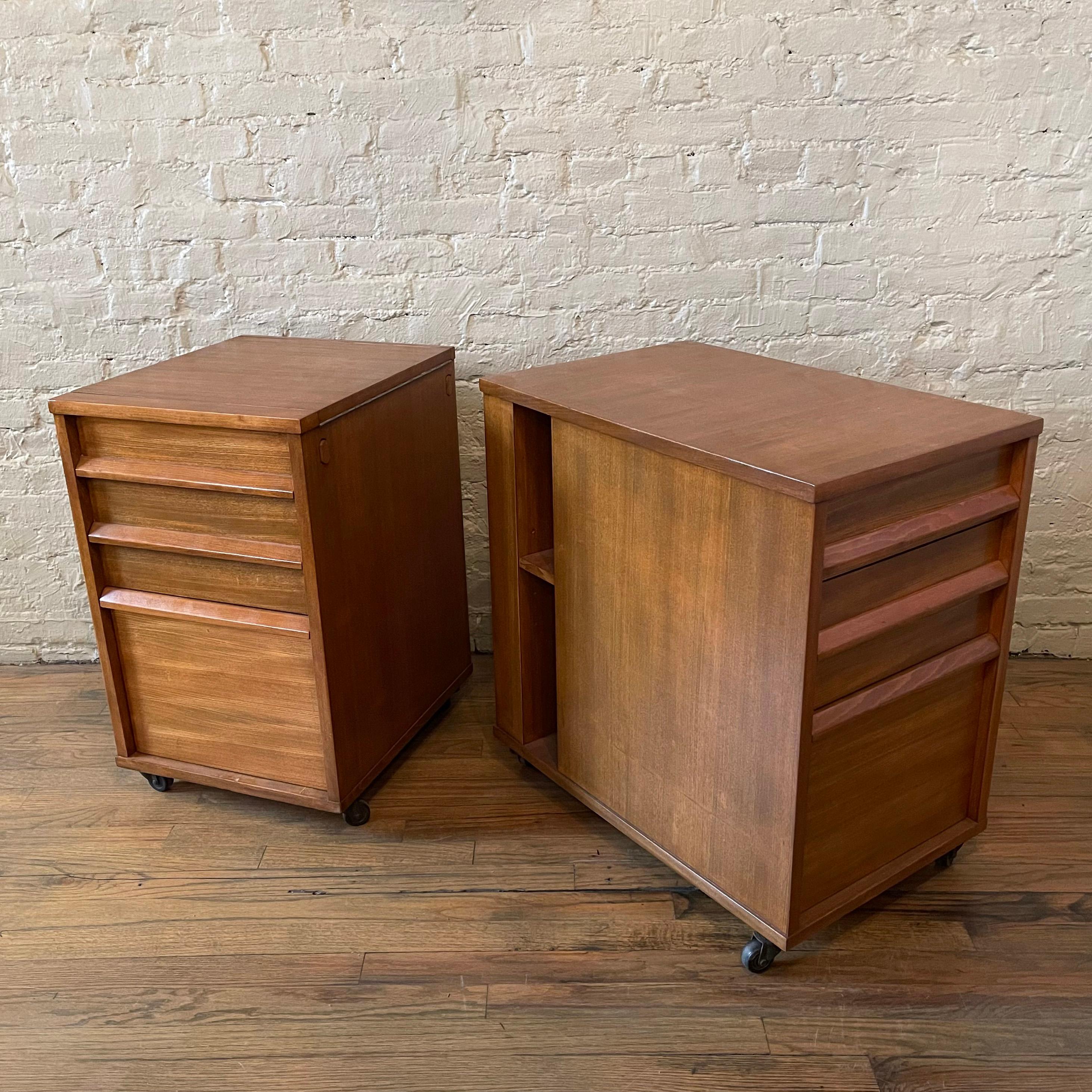 Pair of handsome, walnut, office, filing cabinets by Edward Wormley for Drexel roll on casters with front and top loading, drawer and hanging file storage. One cabinet is shallower at 18.5 inches depth.