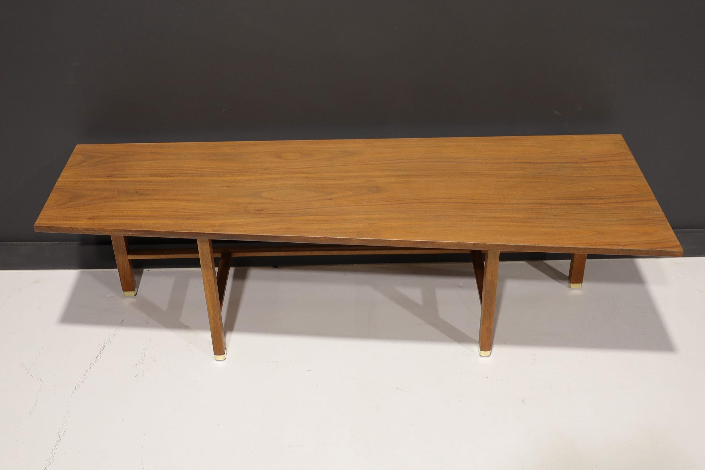 A beautiful design by Edward Wormley for Dunbar. Simple yet interesting with unique trapezoid top and 4 legs with brass caps. 