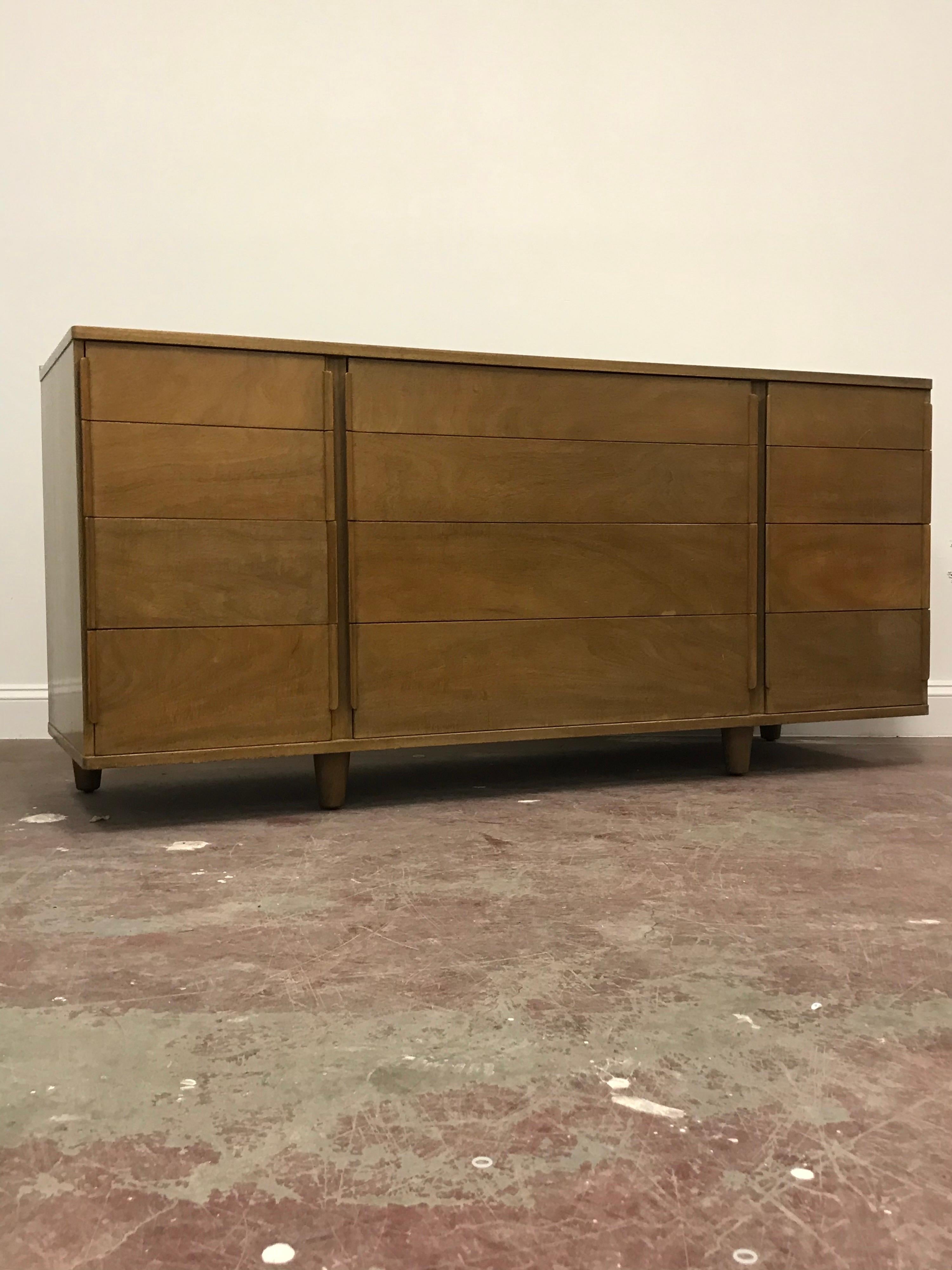 Stunning model 5272A by Edward Wormley for Dunbar. Bleached mahogany dresser consists of 12 drawers with drawer pulls built out of the sides of the drawers..
  