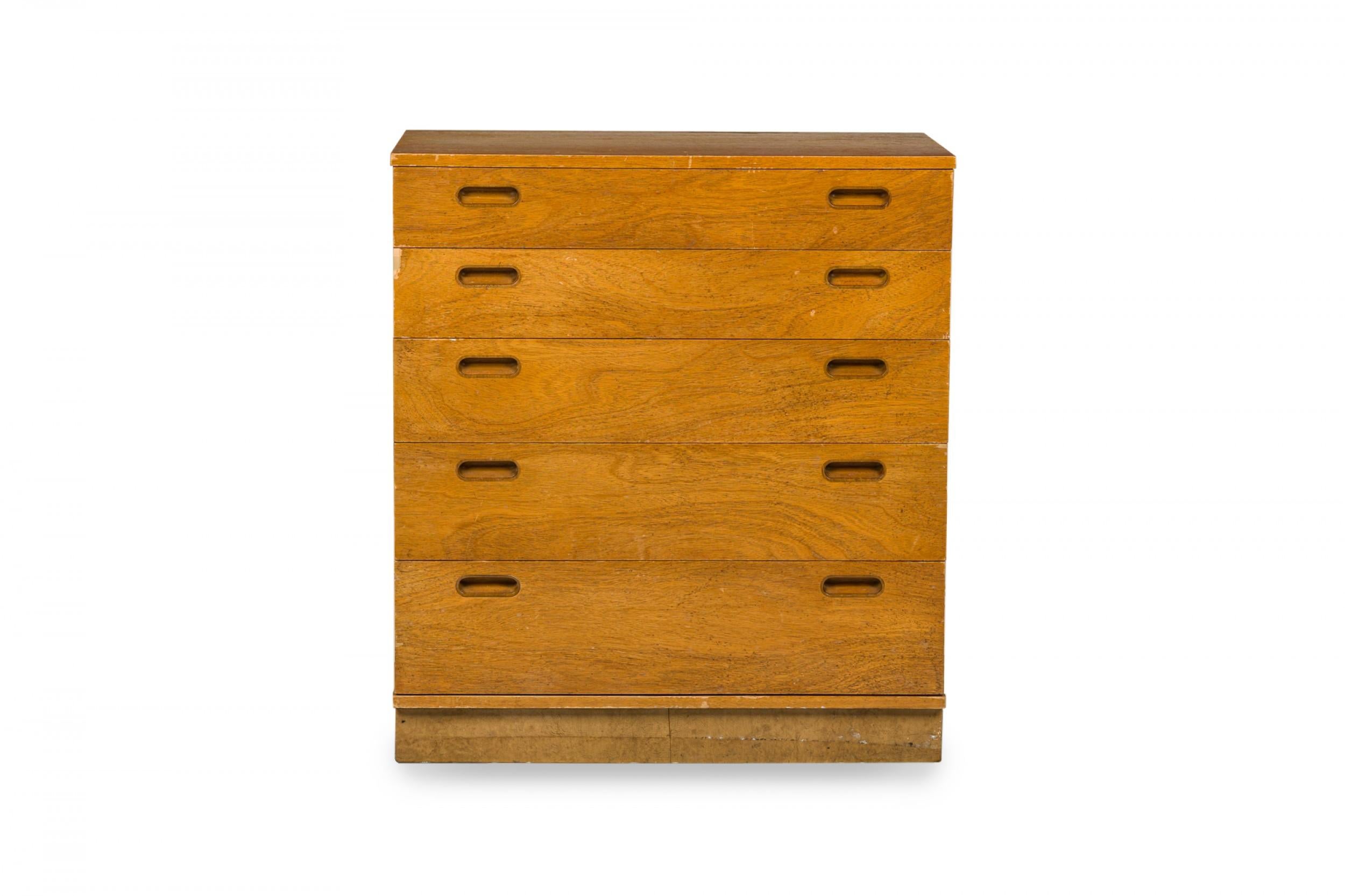 American mid-century wooden chest of drawers with 5 drawers with oval cutout drawer pulls, resting on a pedestal base. (EDWARD WORMLEY FOR DUNBAR FURNITURE COMPANY NEW WORLD COLLECTION)