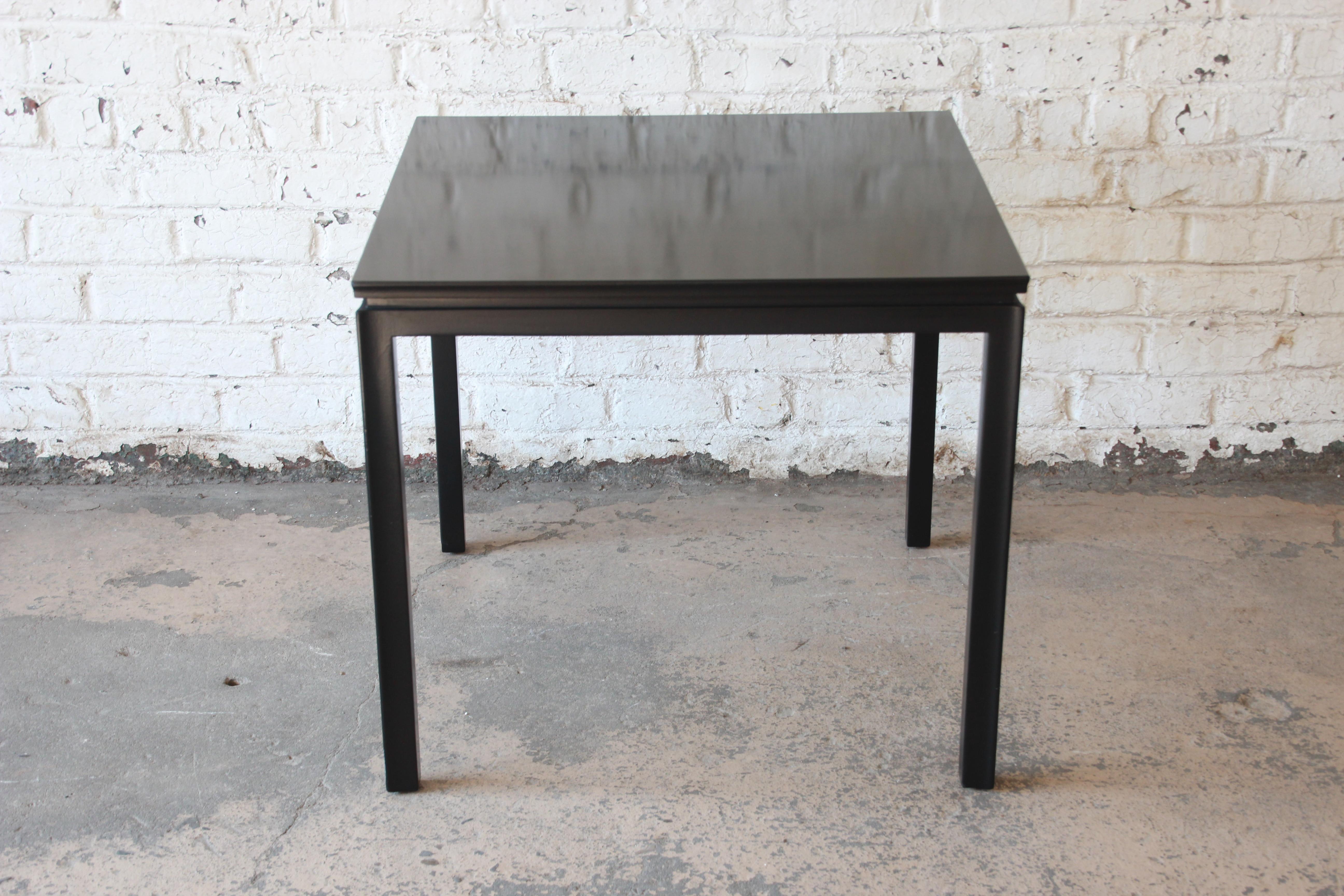 An exceptional Mid-Century Modern game table designed by Edward Wormley for Dunbar. The table features a simple and elegant design and a newly black lacquered finish over mahogany construction. Perfect in a breakfast nook, eat-in kitchen or smaller