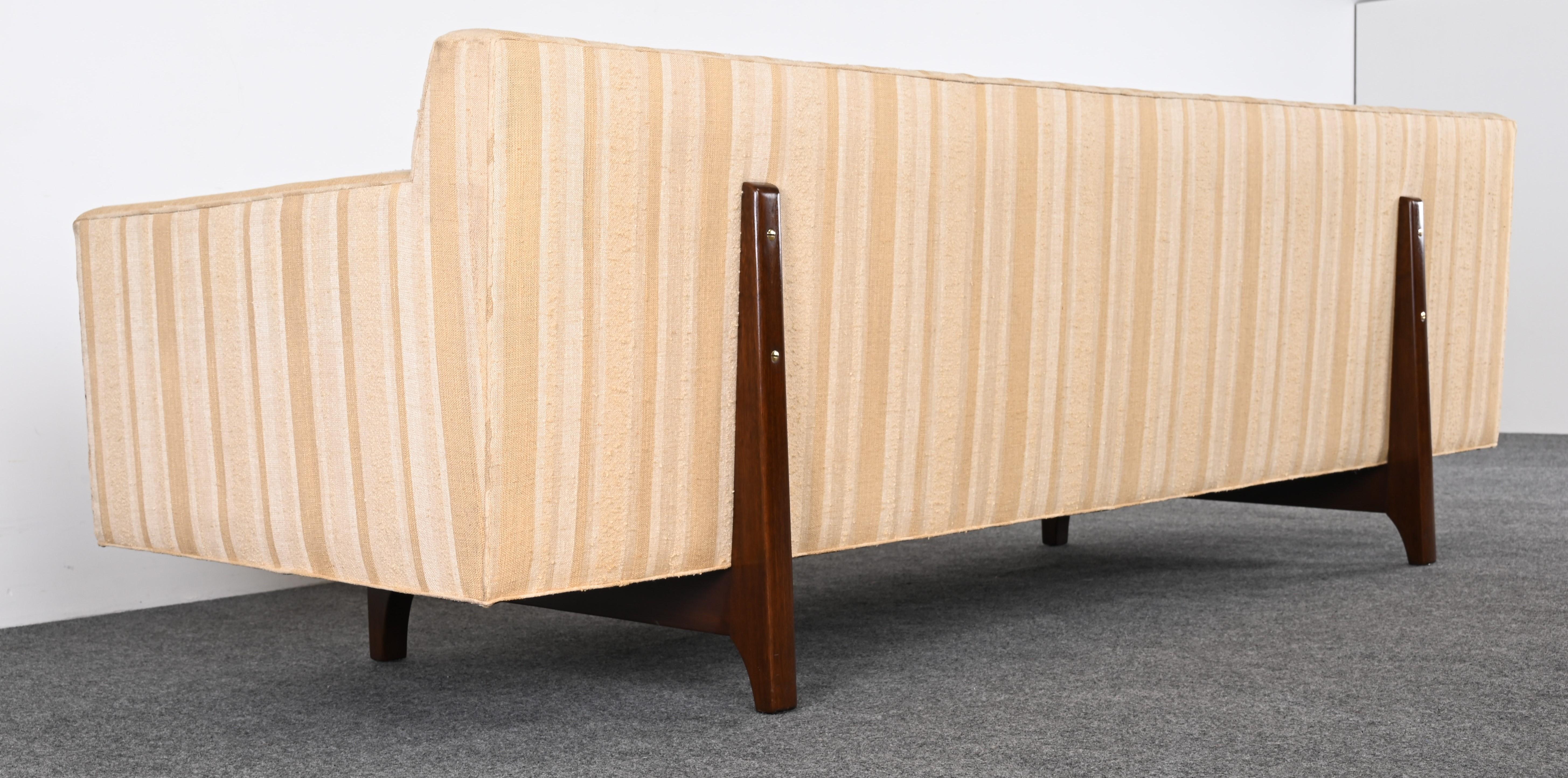 A classic Bracket Back Sofa #5497 by Edward Wormley for Dunbar. Edward Wormley always saw furniture as expressions of personality and as a paired-down concept for detail of architecture and grandeur. This modern line sofa from the 1950s transcends