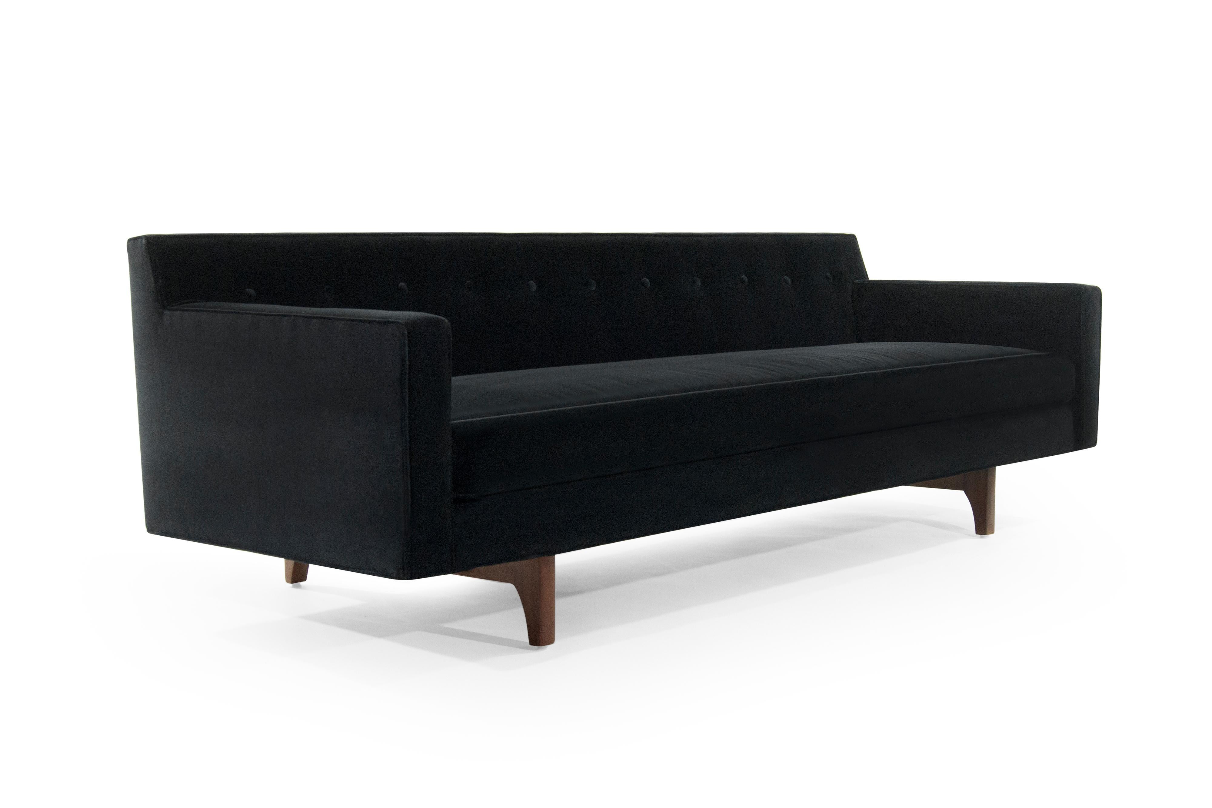 The bracket back sofa produced by Dunbar, designed by Edward Wormley, circa 1950s.

One of Wormley's most iconic designs, walnut legs and back brackets have been fully restored, newly upholstered in black mohair.