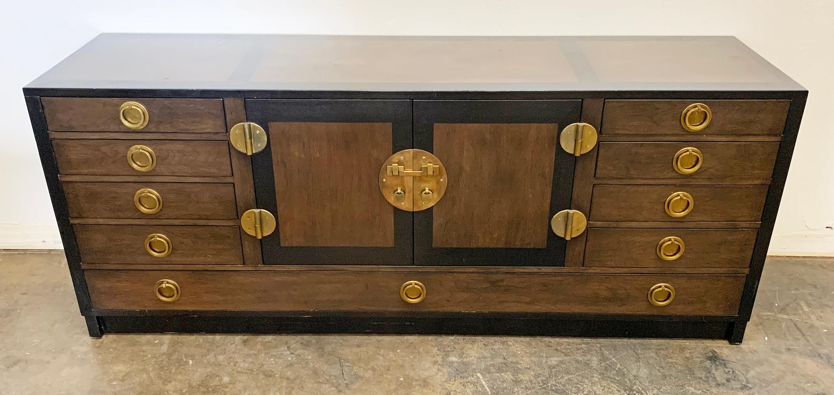 This buffet is absolutely stunning! This ebonized mahogany and walnut sideboard / buffet designed by Edward Wormley for Dunbar features heavy brass accents and pulls in a gorgeous chinoiserie feel.

A piece like this is so elegant and clean it can