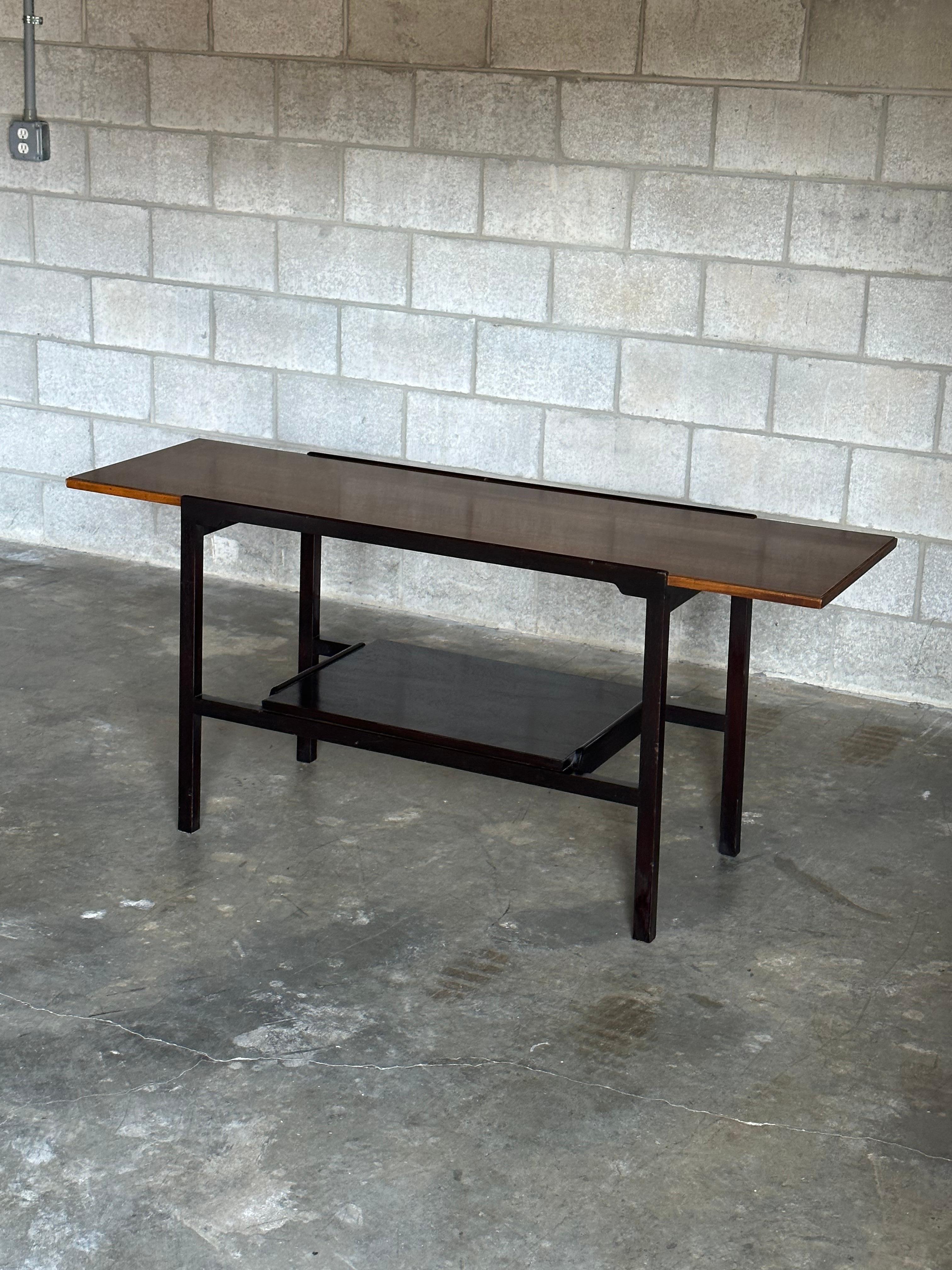 Elegant console table designed by Edward Wormley for Dunbar furniture. Wonderful two-tone color palette along with two tiered design. Would work well as an entry console, or behind a sofa.

Other notable designer from the period include Harvey