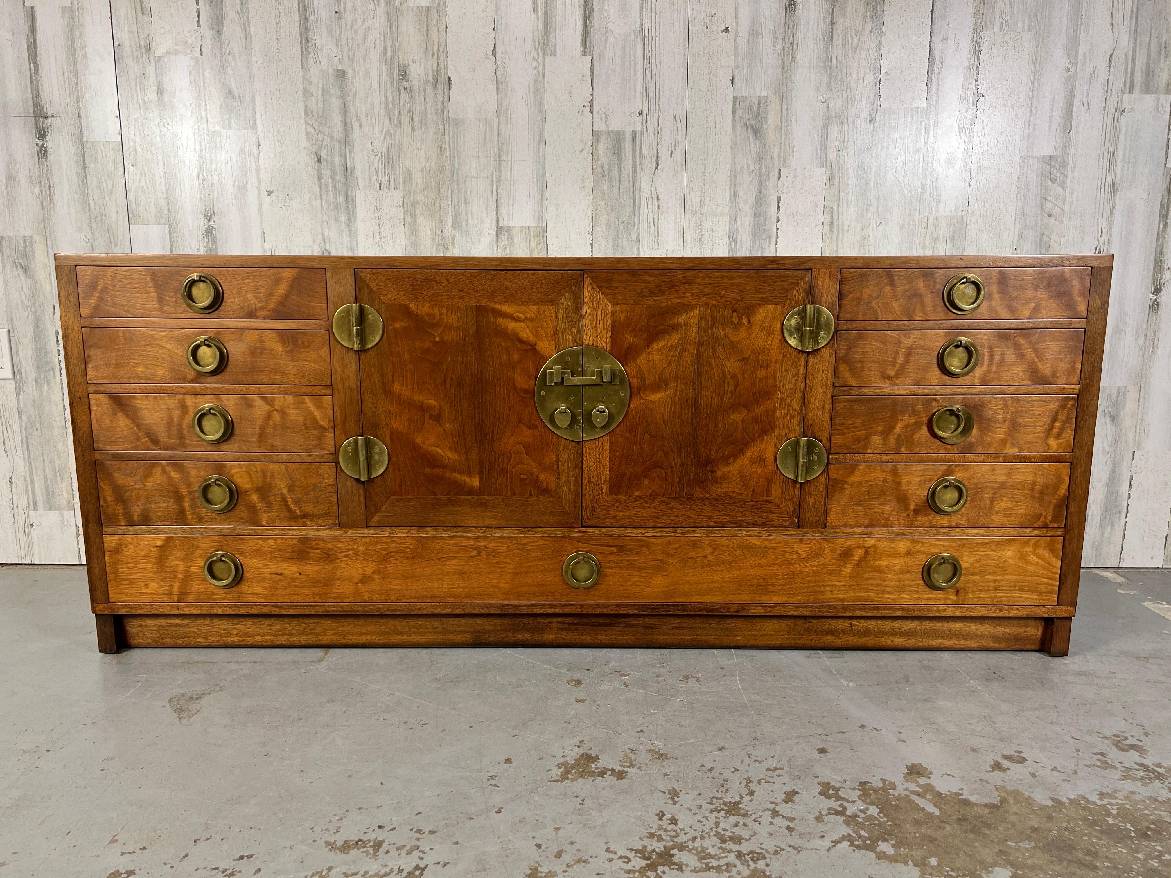 Classic Edward Wormley for Dunbar mahogany credenza with solid brass hardware. Nine drawers with center cabinet.