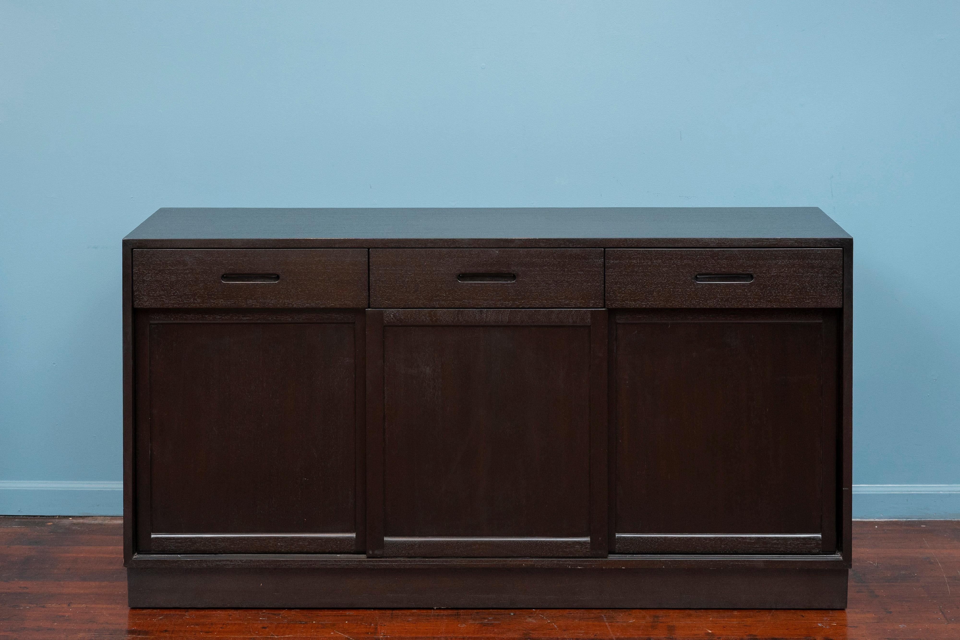 Edward Wormley design credenza for Dunbar Furniture, Berne Indiana. Made with high quality construction technique's and materials. Featuring a fitted interior comprising nine drawers and one adjustable shelf. Sliding doors provide easy storage