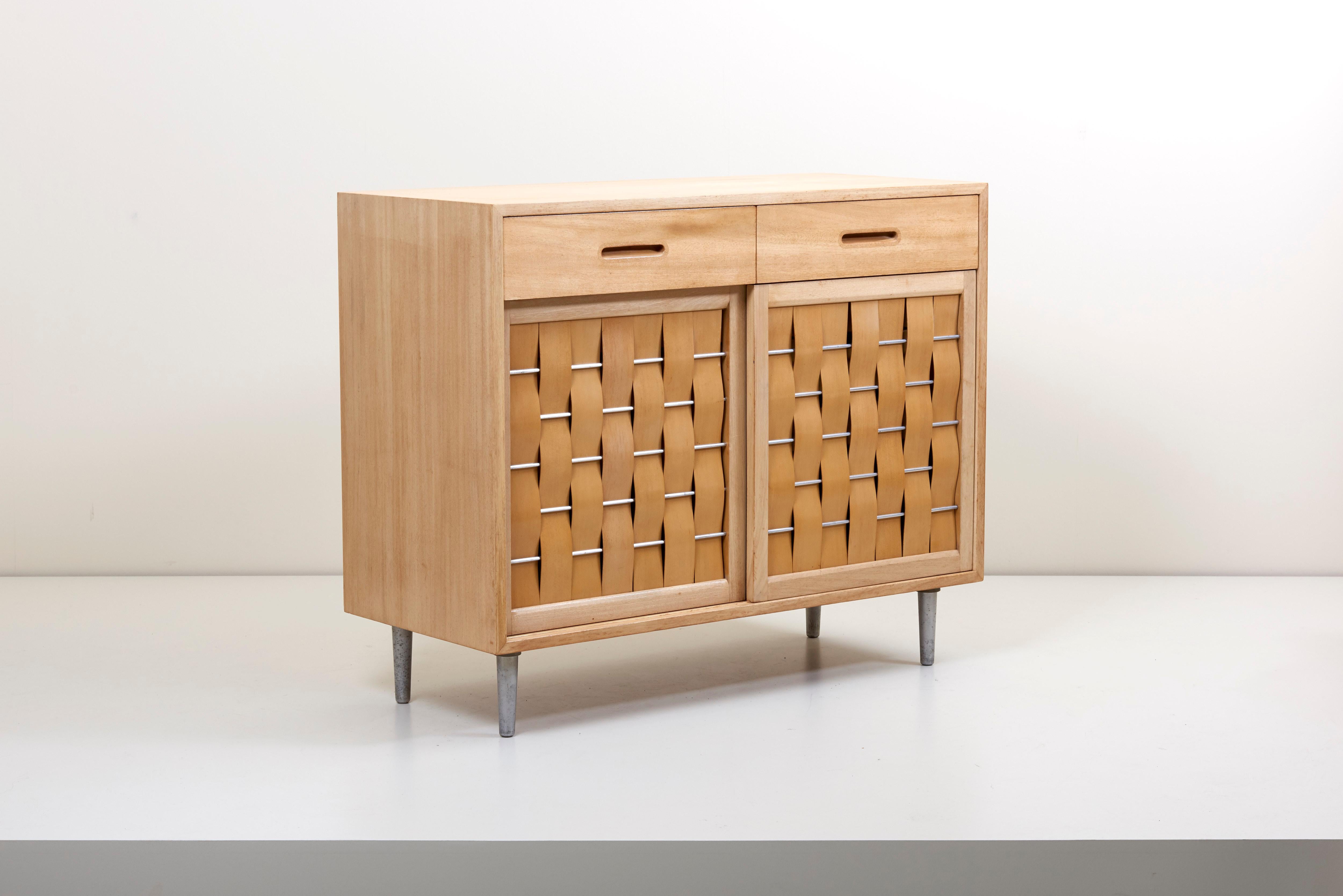 Elegant design by Edward Wormley for Dunbar Furniture Company, Berne Indiana. Perfectly refinished case with two top drawers and sliding woven front doors on metal legs. Fitted interior comprises six drawers.