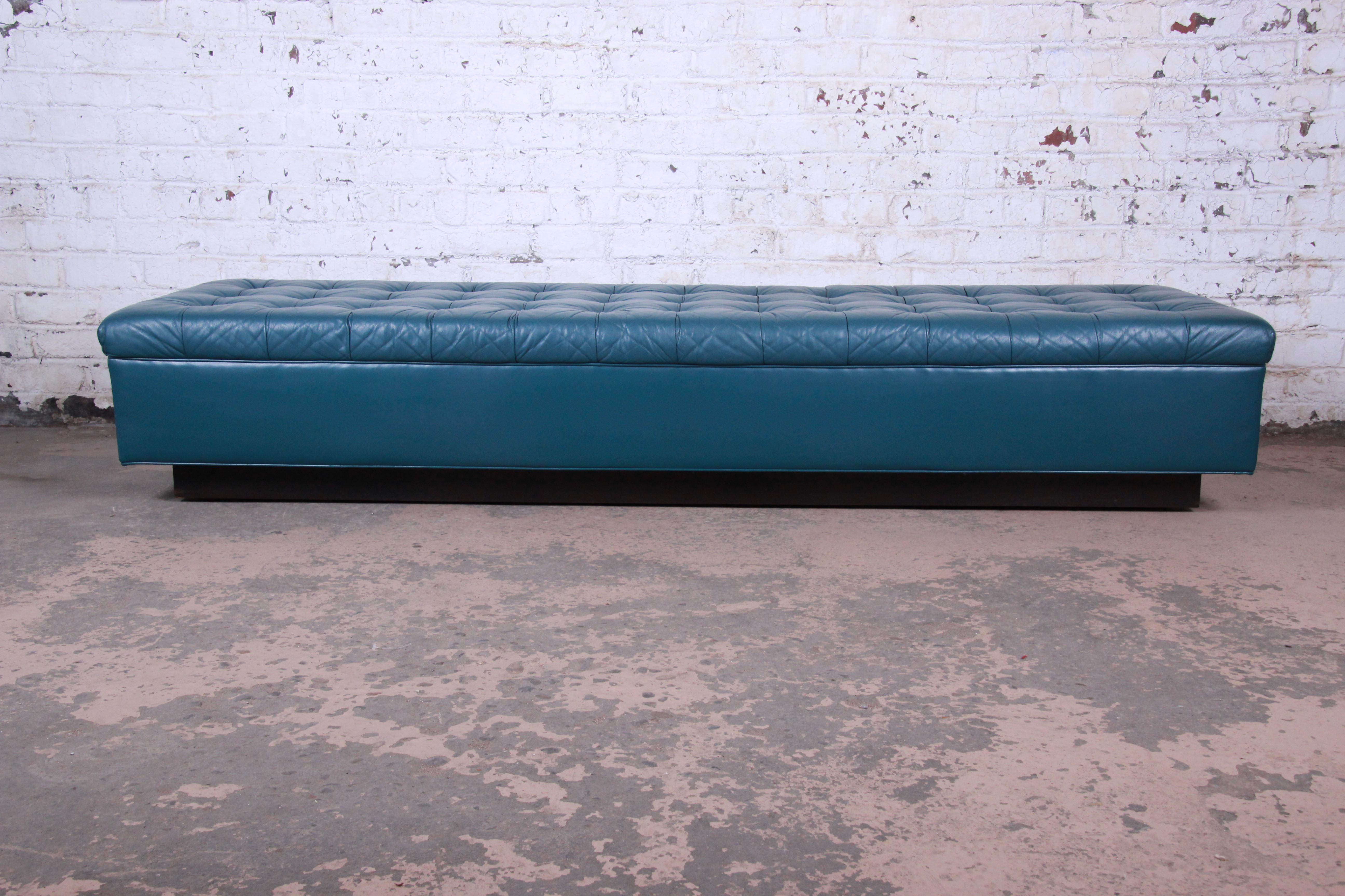 A rare and exceptional Mid-Century Modern custom tufted leather bench by Edward Wormley for Dunbar. The bench features gorgeous high grade tufted teal leather on an ebonized plinth base. A sleek and stylish bench--an excellent example of Wormley's