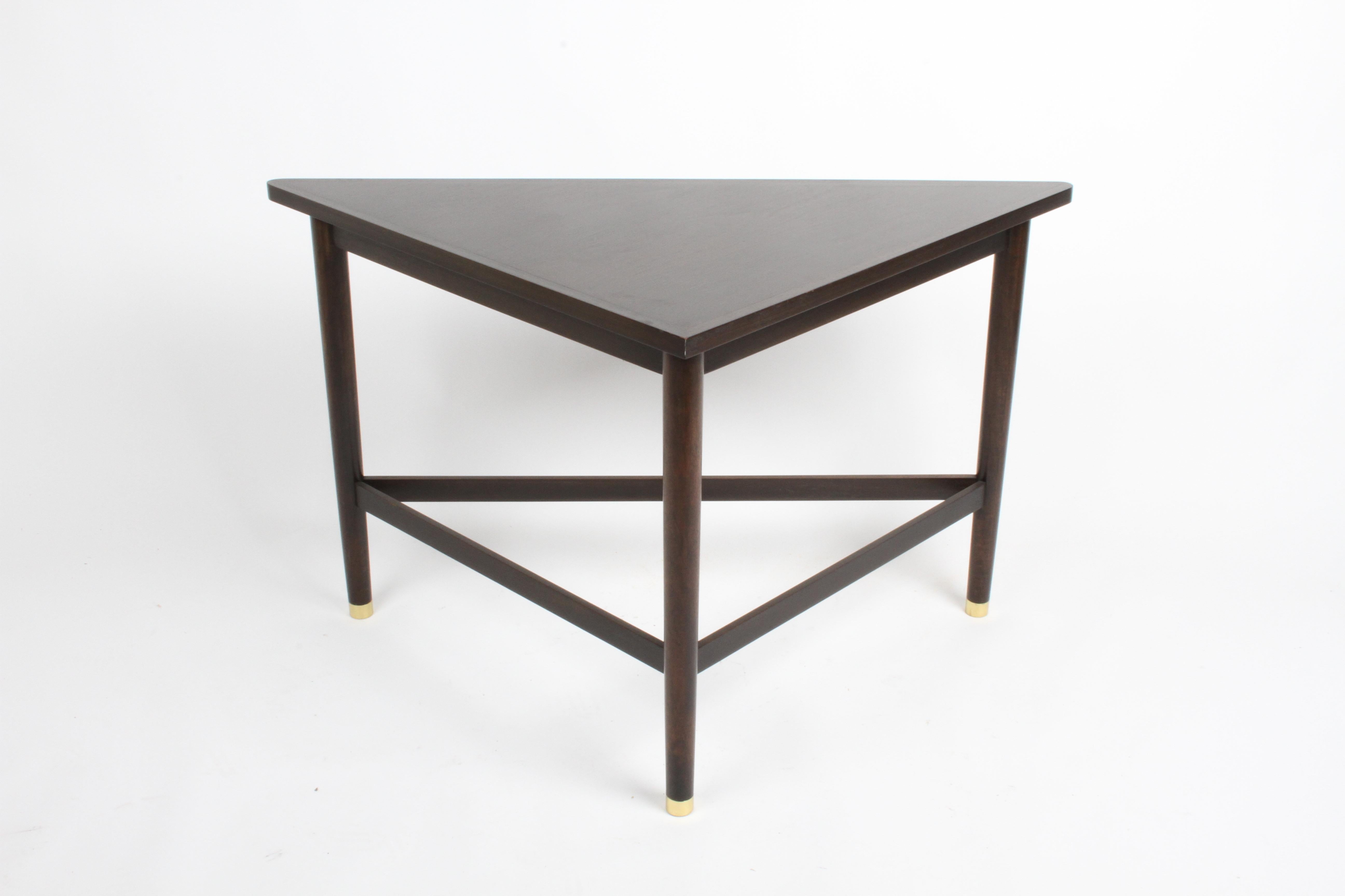 Edward Wormley for Dunbar, all original wedge / triangle shape corner or sofa table in original dark mahogany on brass sabots. Top shows wear, top can be refinished for additional cost. Dunbar D label.