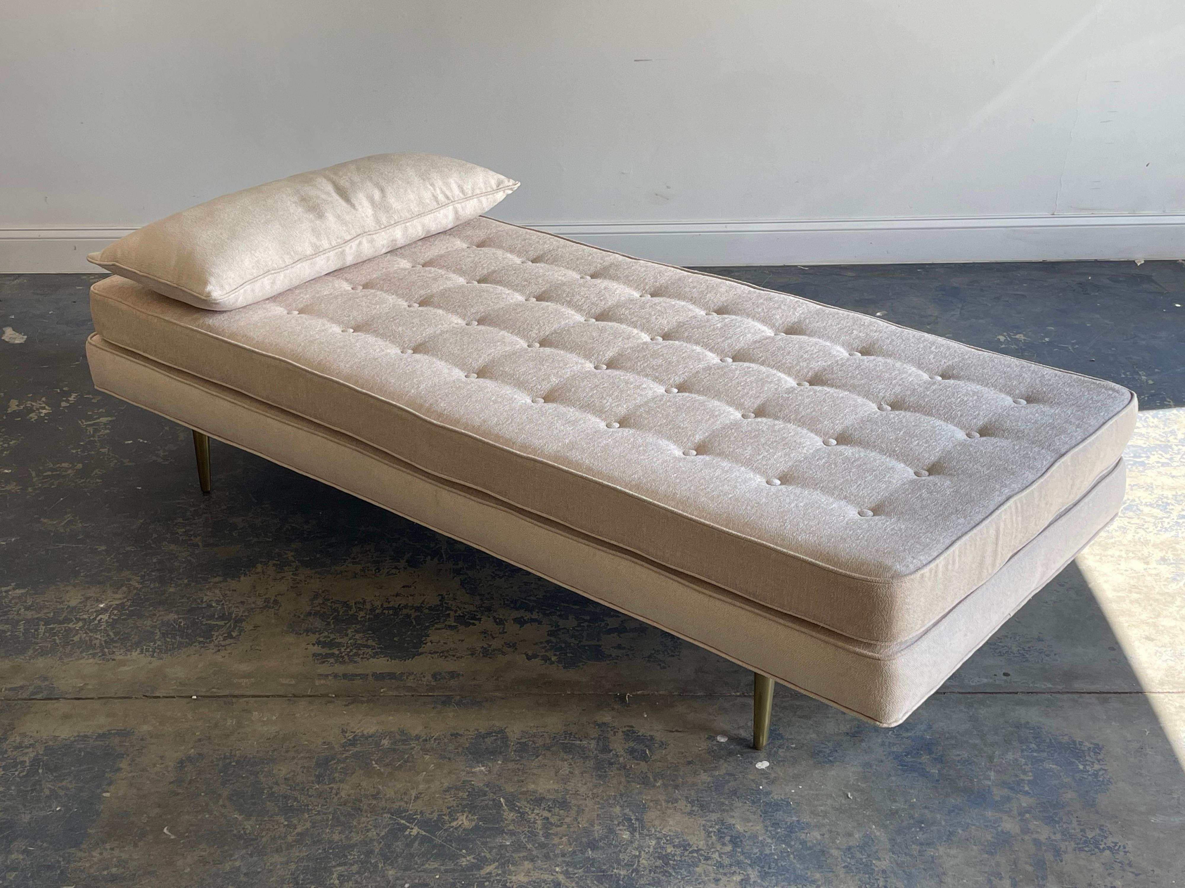 A large daybed or chaise designed by Edward Wormley for Dunbar. Loose tufted cushion with a custom accent pillow. Supported by four solid brass legs.

Would work well in a variety of interiors such as modern, mid century modern, contemporary, etc.
